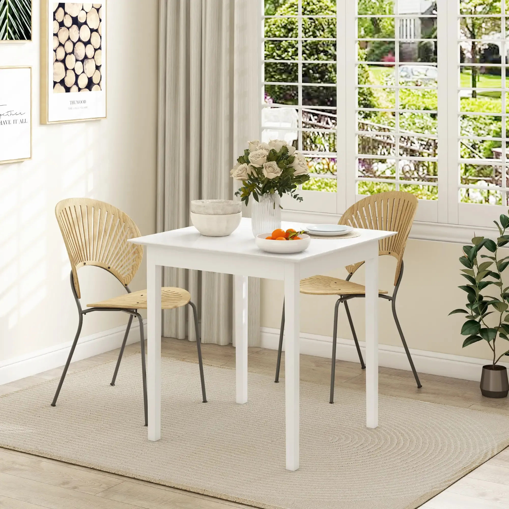 Ein weißer Tisch mit zwei Stühlen ist für eine Mahlzeit gedeckt. Eine Vase mit Blumen steht in der Mitte. Im Hintergrund ist ein Fenster mit Grün.