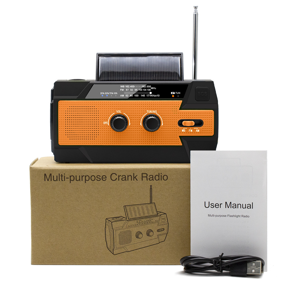 Ein schwarzes und orangefarbenes Mehrzweck-Kurbelradio mit Solarpanel, Benutzerhandbuch, Box und Ladekabel.