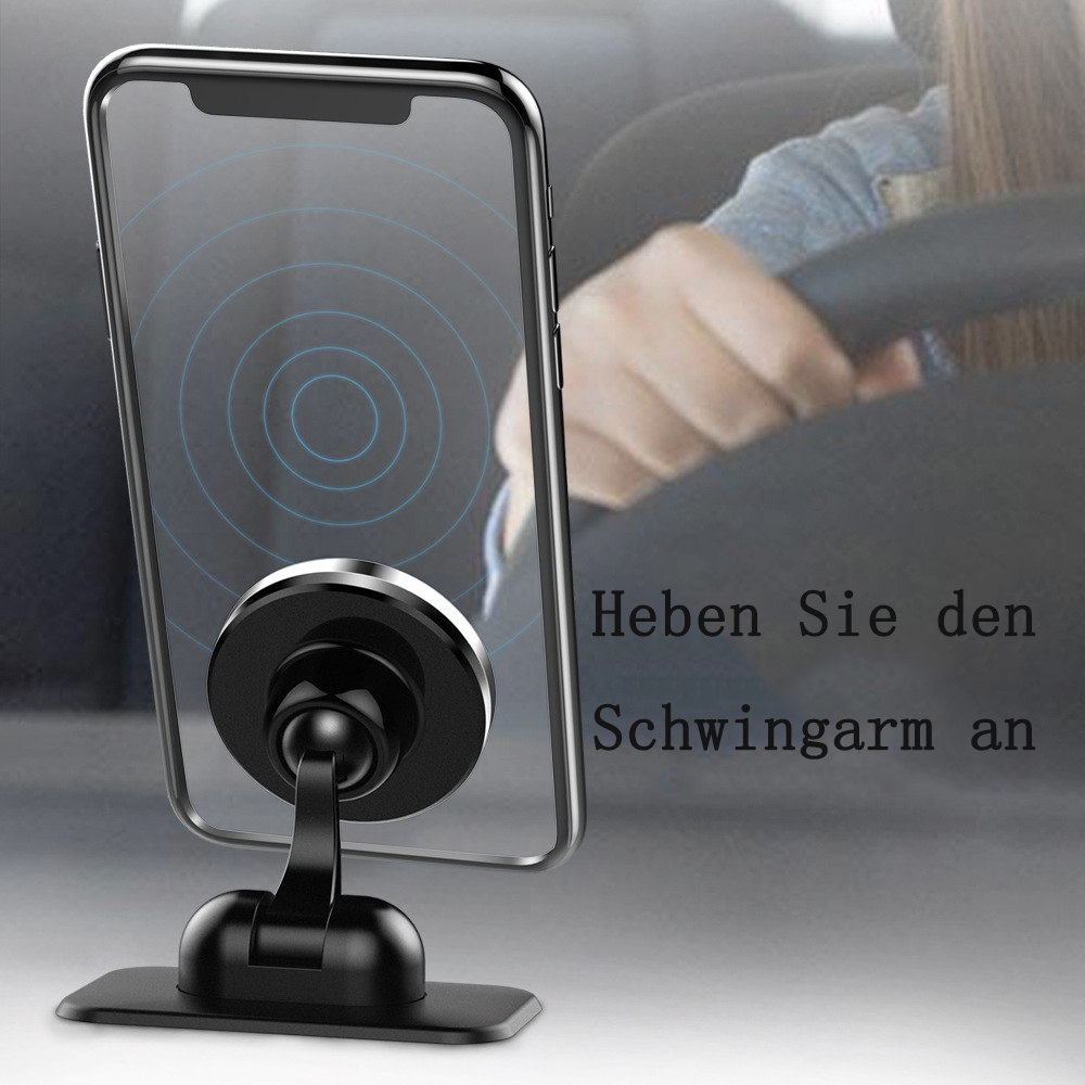 Ein Telefon ist an einem schwarzen Autotelefonhalter befestigt. Im Hintergrund hält eine Person ein Lenkrad. Text auf Deutsch ist sichtbar.