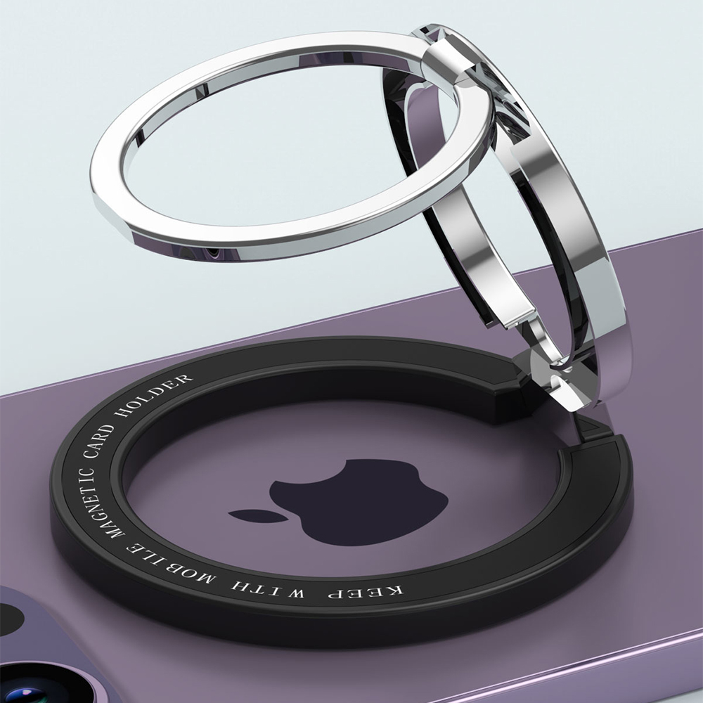 Ein silberner Telefonringhalter auf einem lila Telefon. Der Halter ist kreisförmig, mit schwarzer Basis und Apple-Logo.
