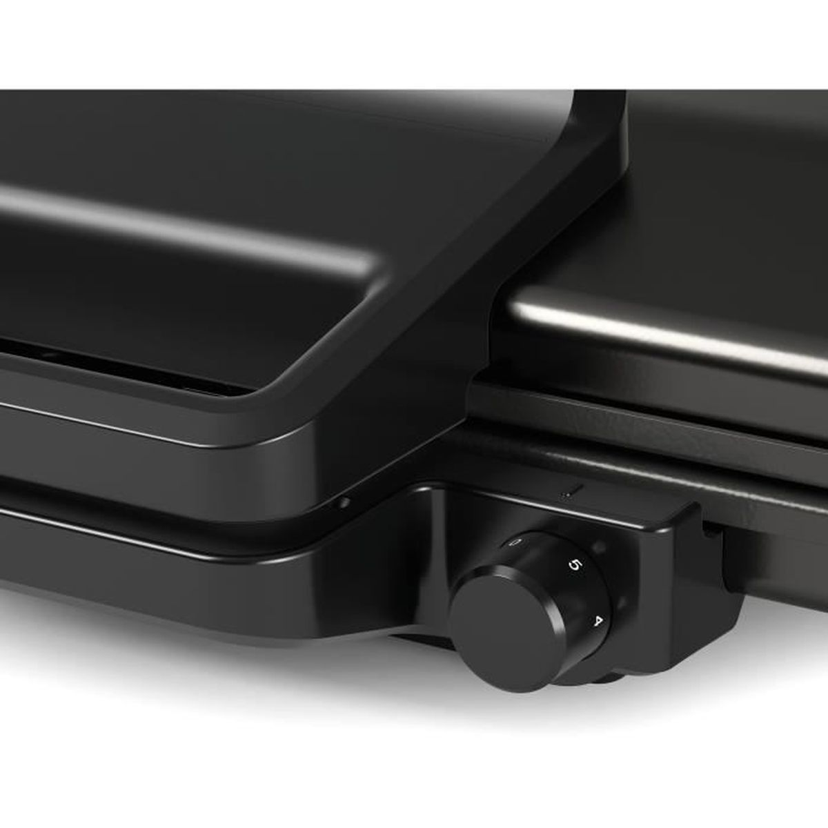 Close-up of a black appliance with a dial. The dial is numbered 1-5. The appliance has a shiny, smooth surface.