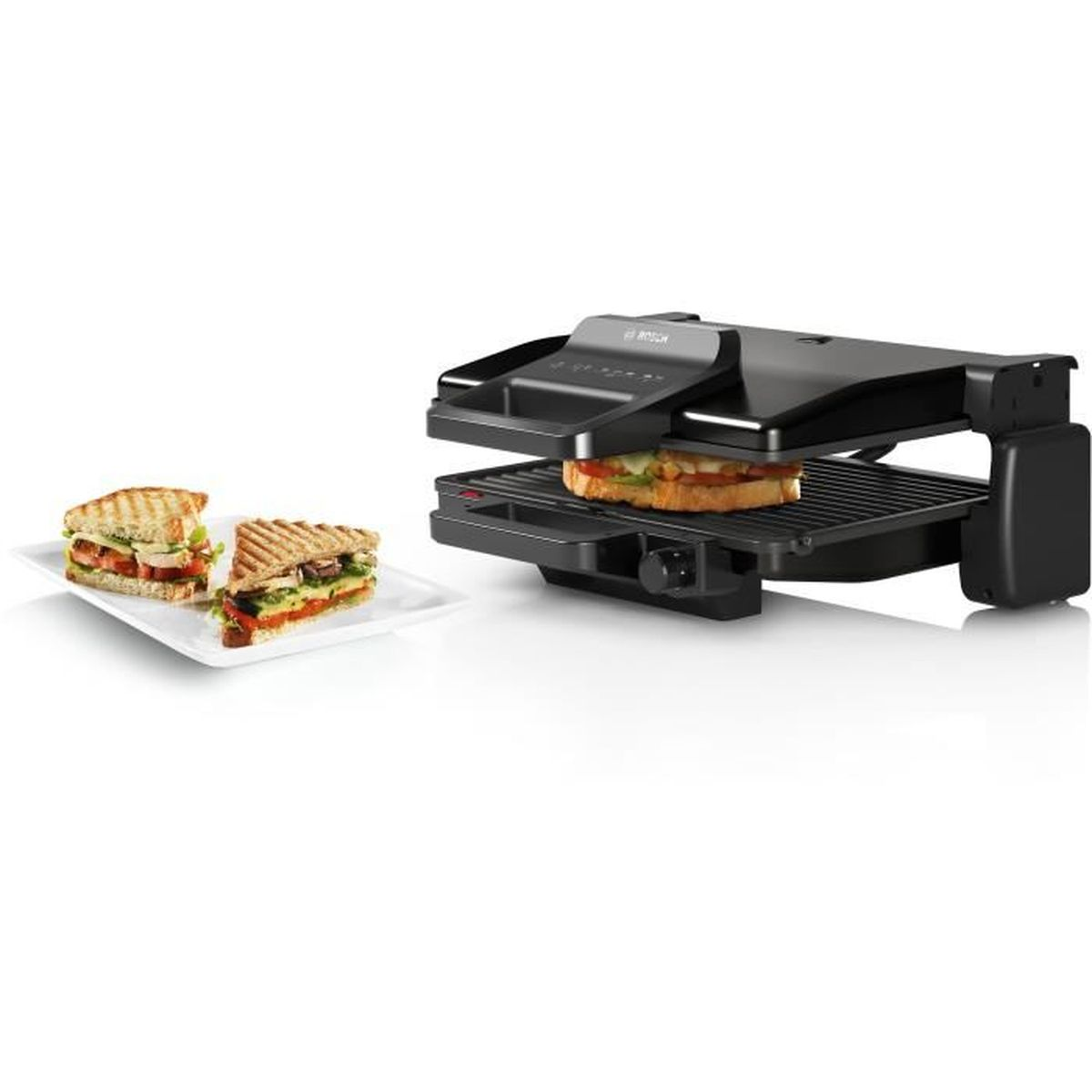A black sandwich press with a sandwich inside. Two sandwiches on a white plate are on the left.