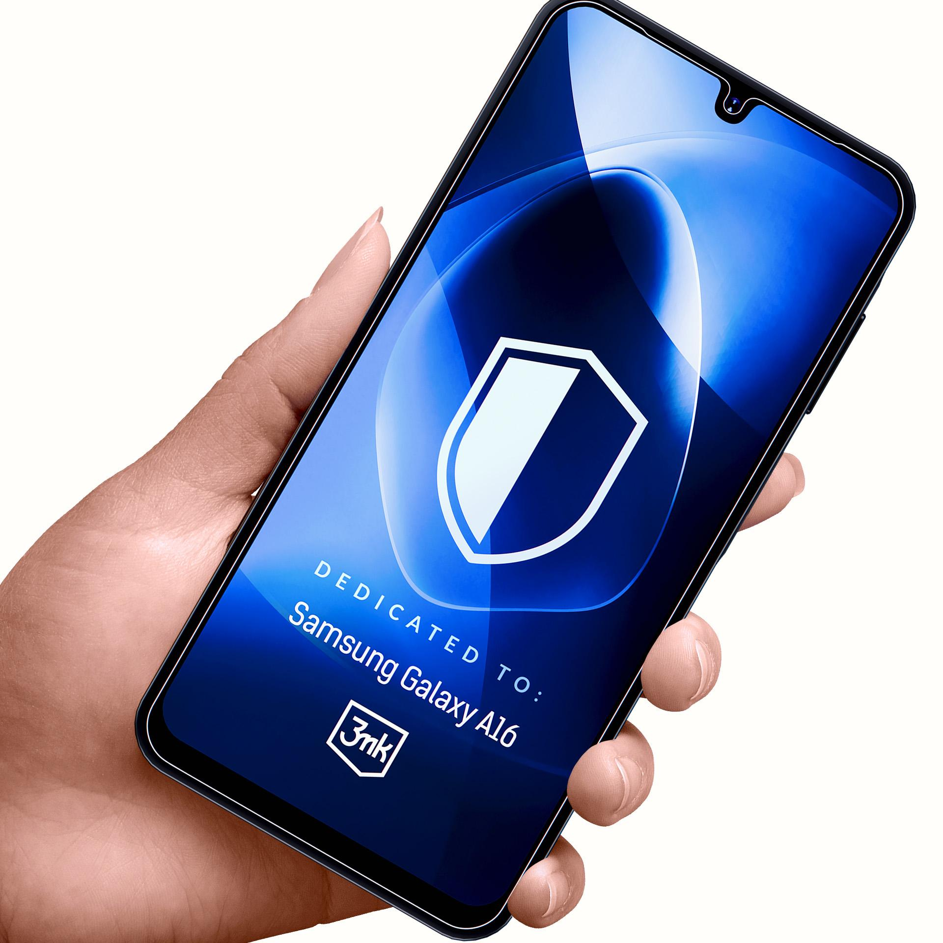 Ręka trzyma telefon z niebieskim ekranem. Ekran pokazuje białą tarczę. Tekst: Dedykowane dla Samsung Galaxy A16.