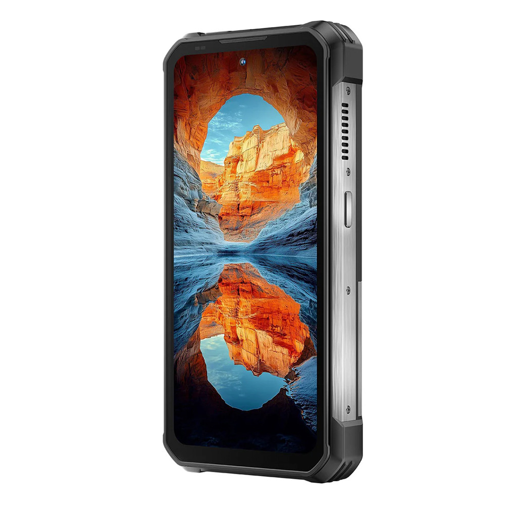 Smartphone robusto. Lo schermo mostra un canyon con riflesso dell'acqua. Cassa nera e argento. Pulsanti laterali e porte visibili.