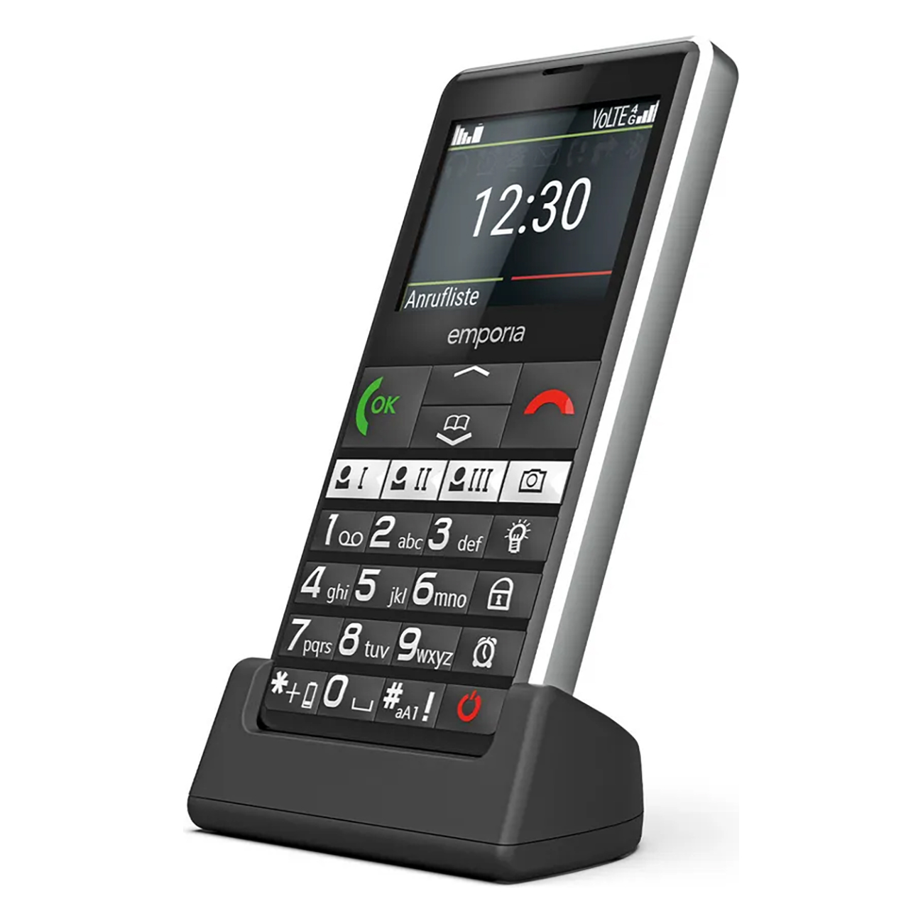 Un telefono cellulare nero e argento è in una base di ricarica. Lo schermo mostra l'ora e le funzioni del telefono. I tasti numerici sono visibili.