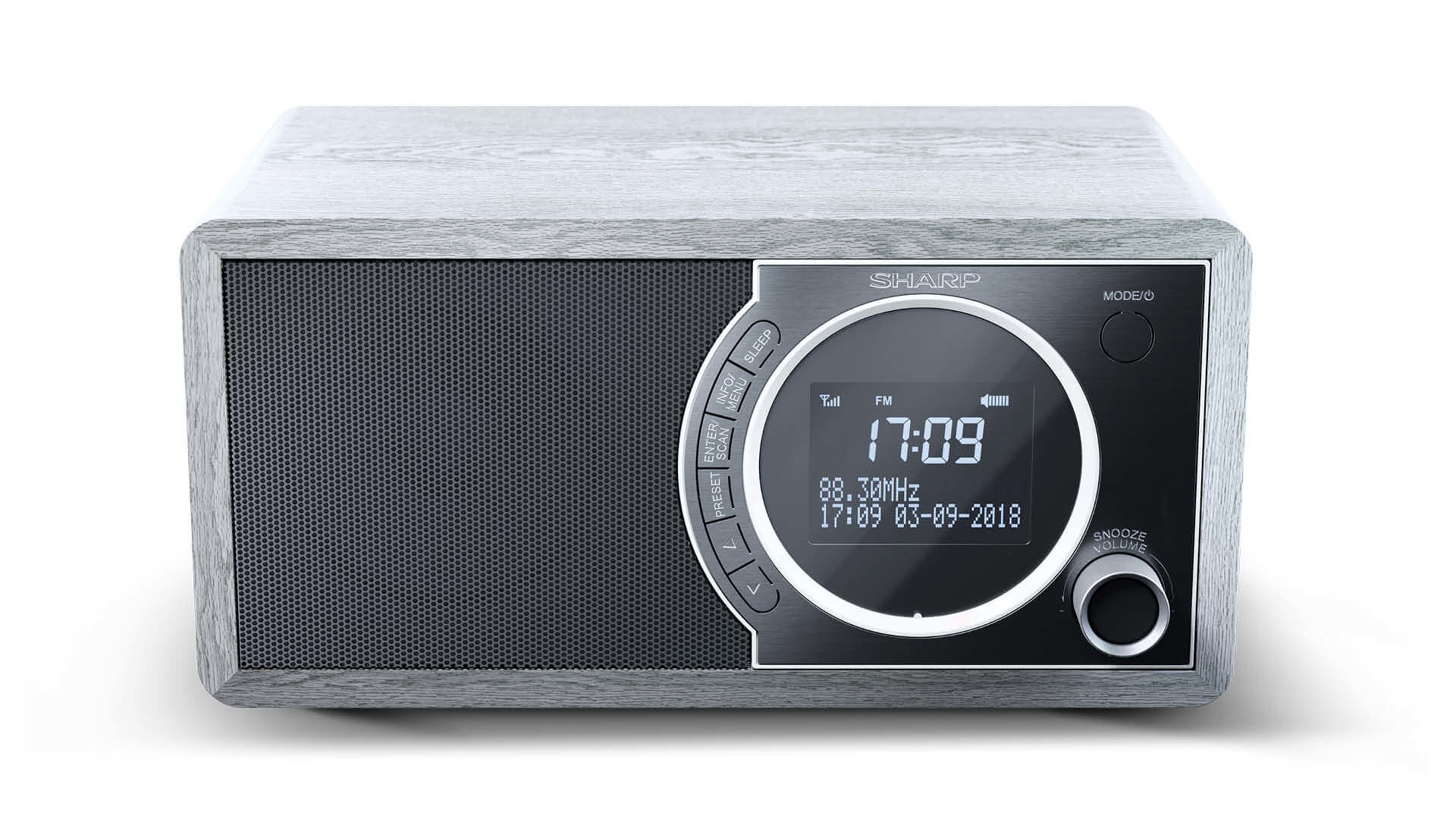 A gray wooden Sharp digital radio displays the time, date, and FM frequency. Buttons and a volume knob are visible.