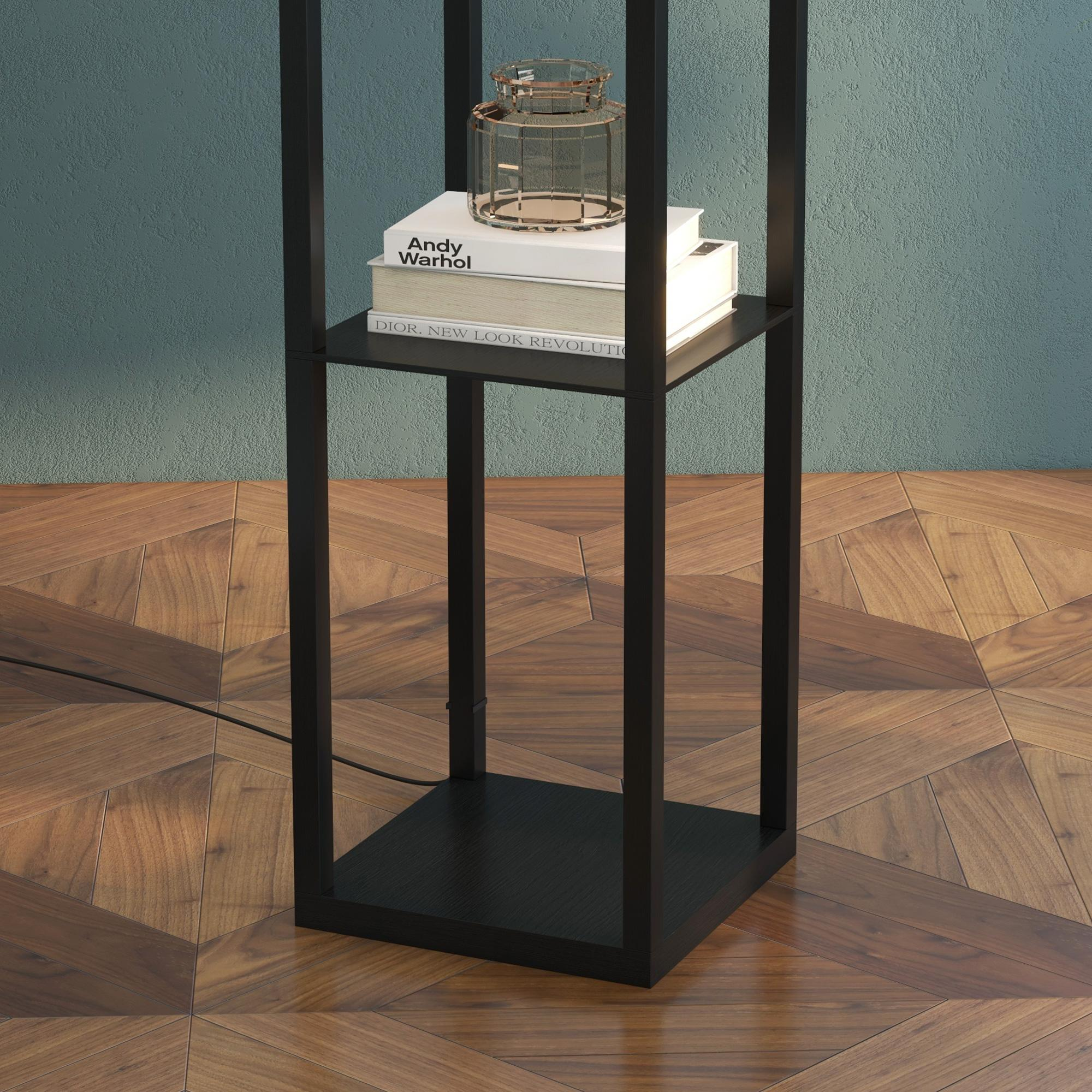 Ein schwarzes Metallregal mit Büchern und einem Glas steht auf einem Holzboden. Die Wand ist blaugrün.