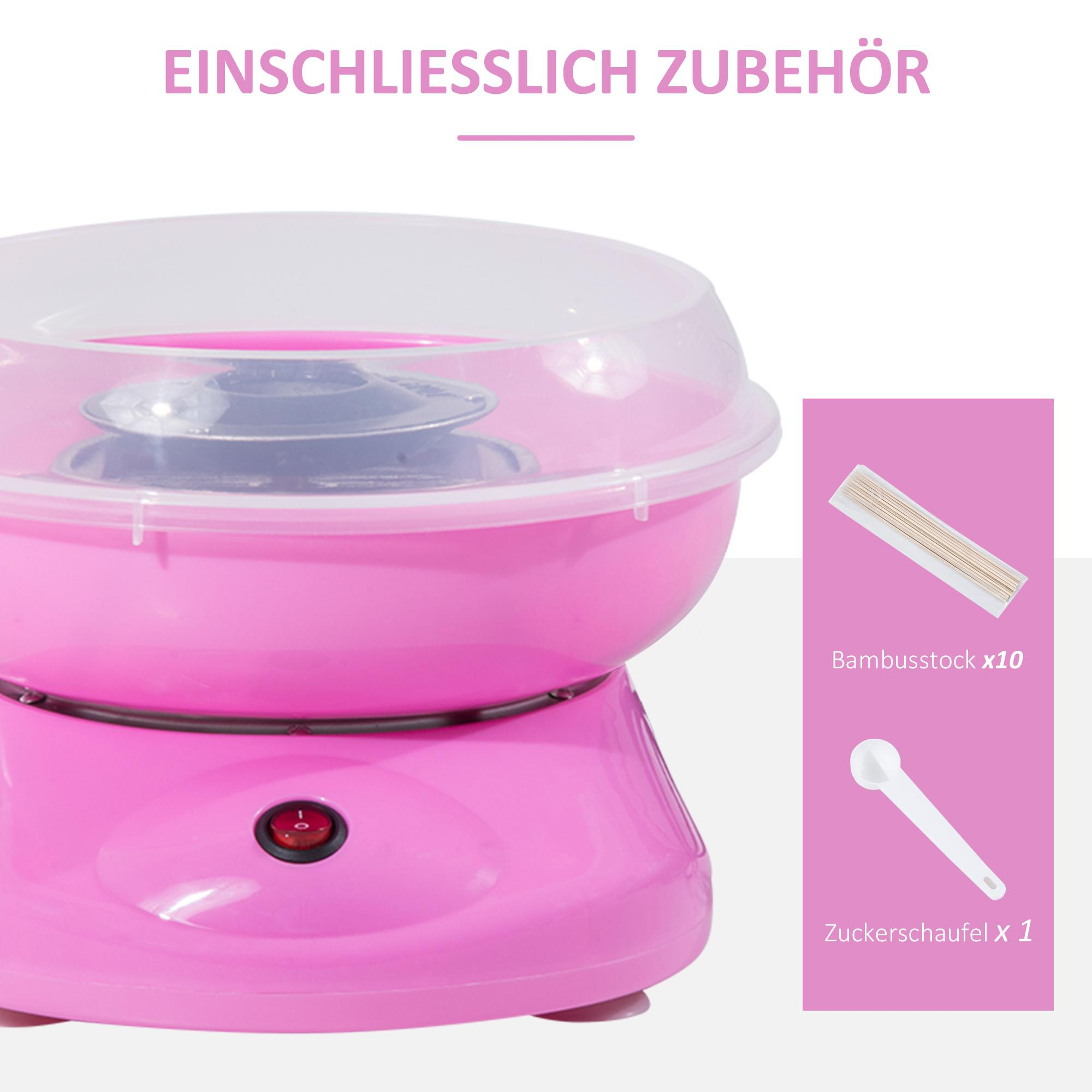 Rosa Zuckerwattemaschine mit Zubehör. Enthält Bambusstäbchen und einen Zuckerlöffel. Text: 'EINSCHLIESSLICH ZUBEHÖR'.
