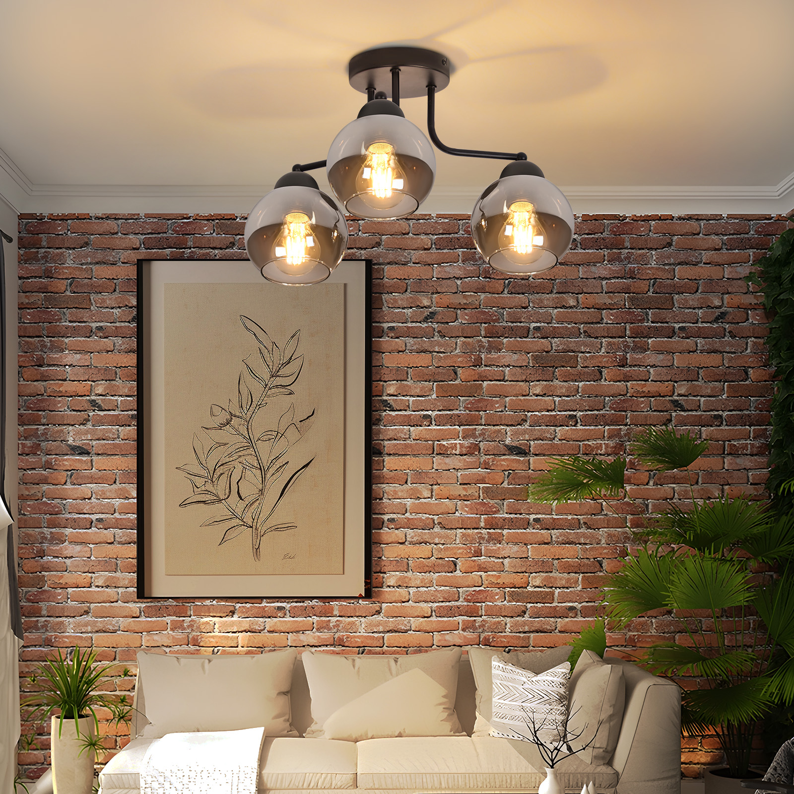 Salón con pared de ladrillo, sofá, impresión botánica enmarcada, plantas y lámpara de tres luces.