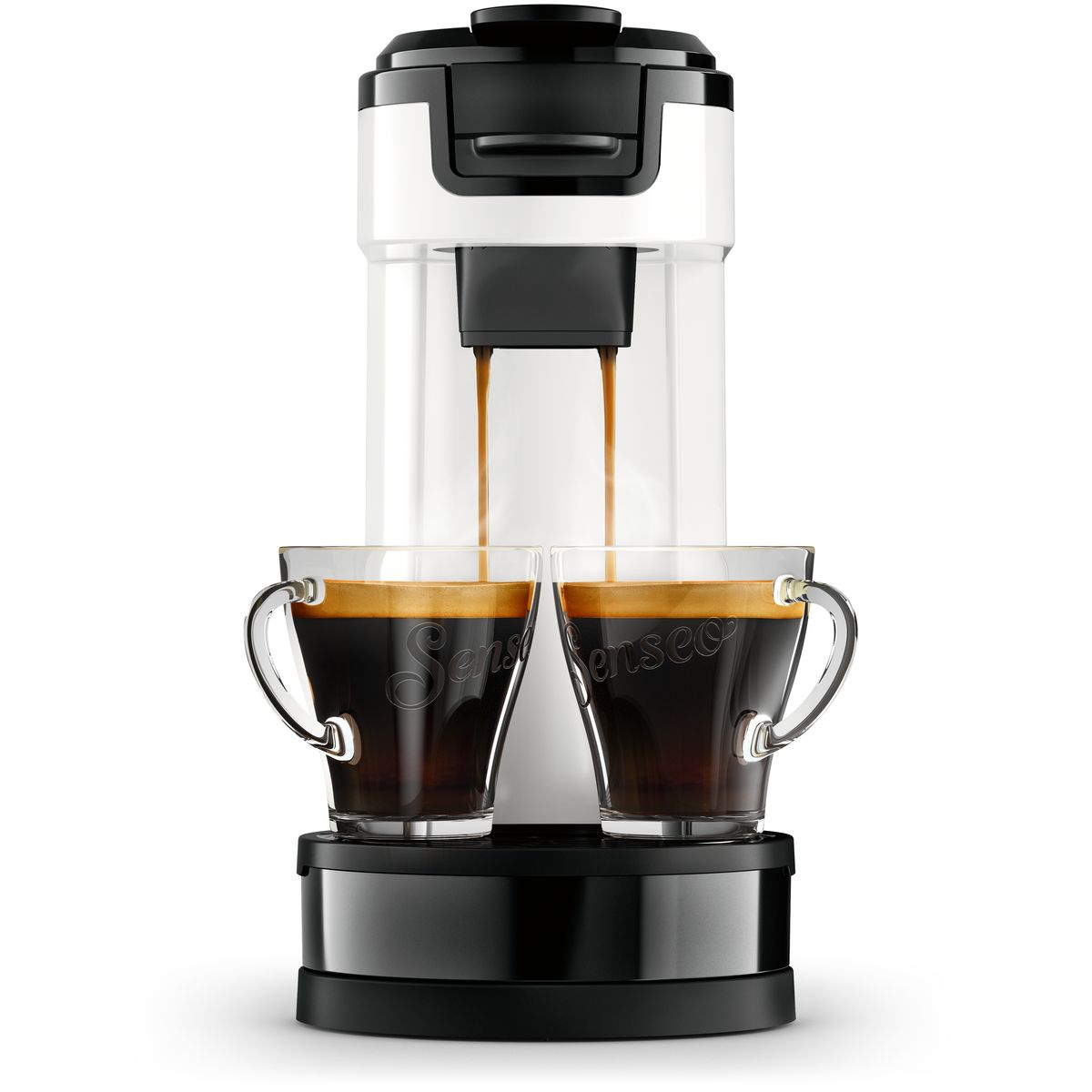 Ekspres do kawy dozujący kawę do dwóch szklanych filiżanek. Maszyna jest biało-czarna, kawa jest ciemnobrązowa.