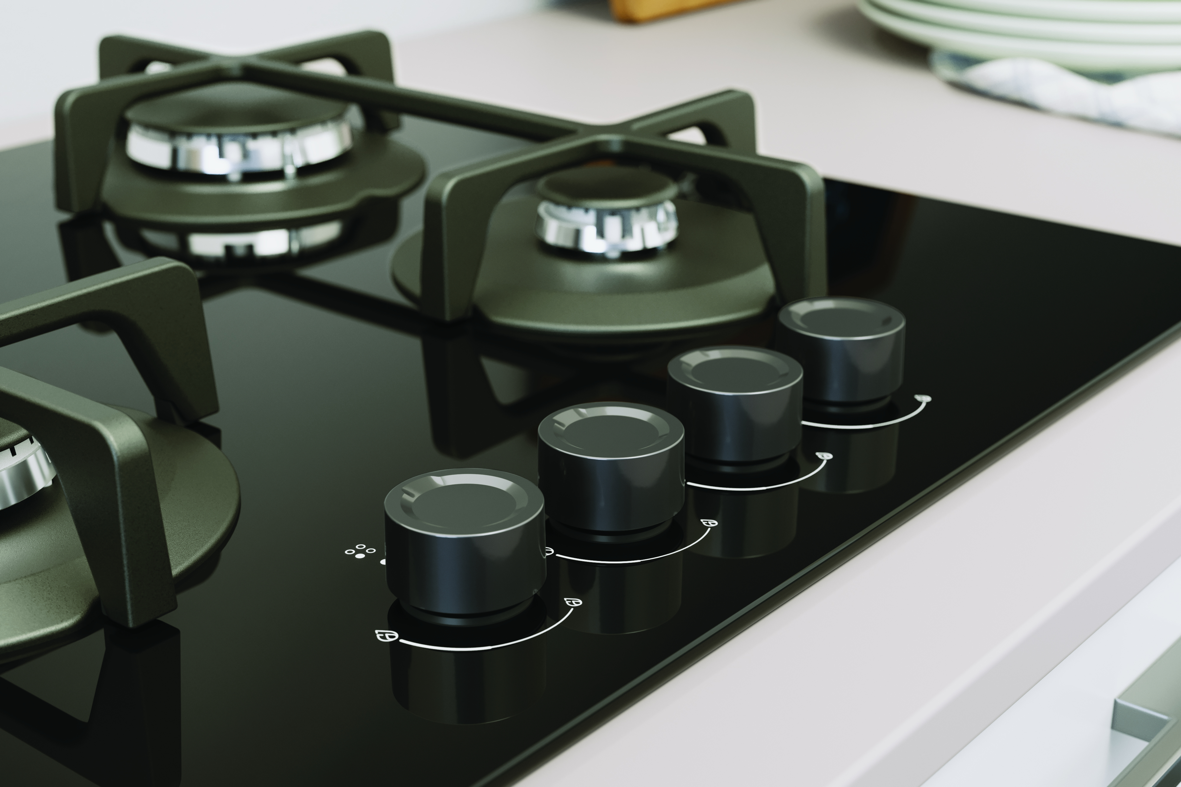 Czarna szklana płyta kuchenna z palnikami i czterema czarnymi pokrętłami. Pokrętła kontrolują palniki.