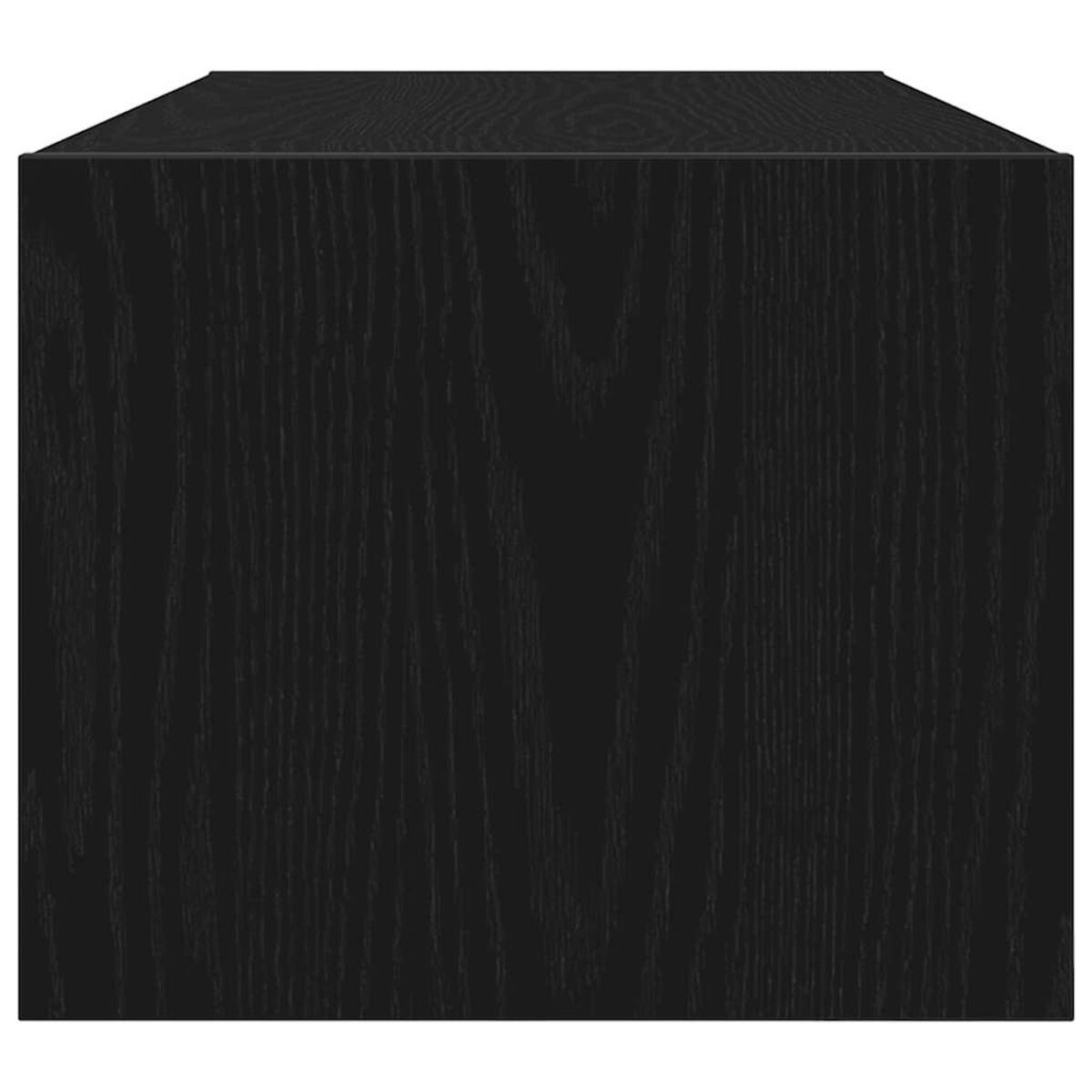 Nahaufnahme eines schwarzen Holzcubes, die Maserung ist sichtbar. Der Cube steht auf einer weißen Oberfläche.