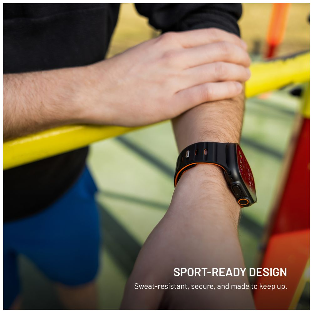 Ein Arm mit einer schwarz-orangenen Smartwatch. Die Person befindet sich in der Nähe einer gelben Stange. Sportliches Design.