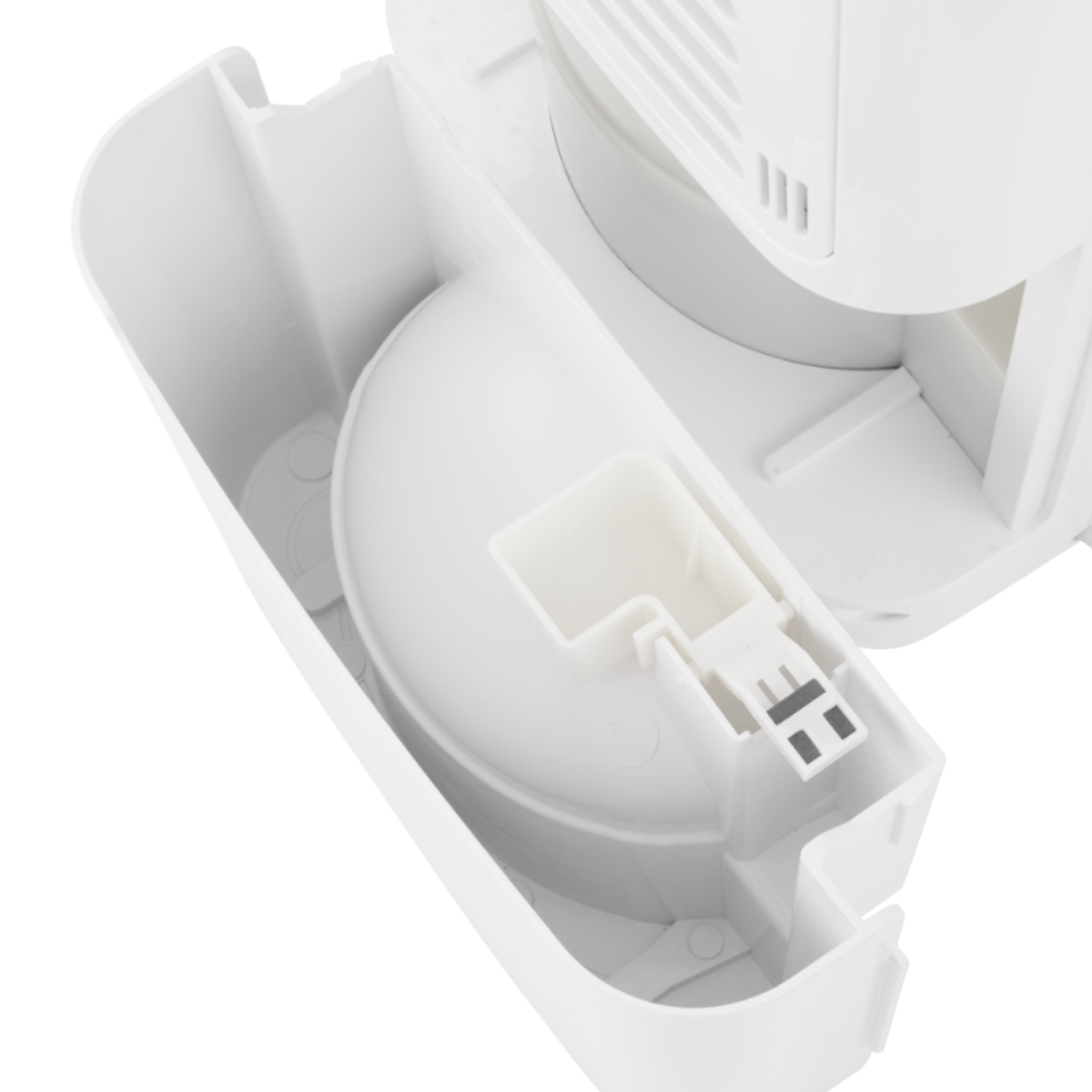 A close-up of a white plastic device, showing its inner parts. It has a circular container. The device is on a white background.