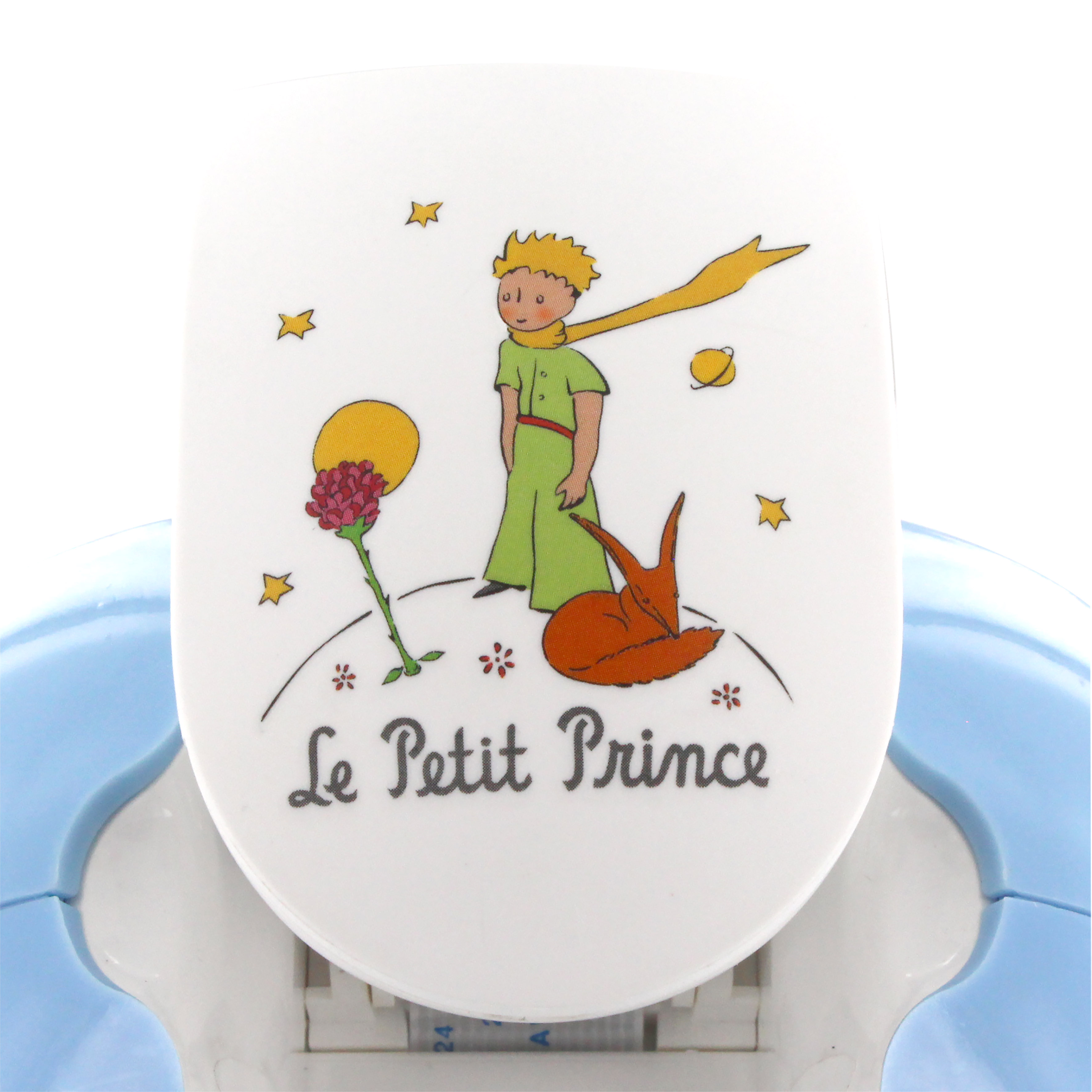 Una superficie blanca presenta un diseño del Principito. El Principito, el zorro y la rosa son visibles. Plástico azul rodea el diseño.