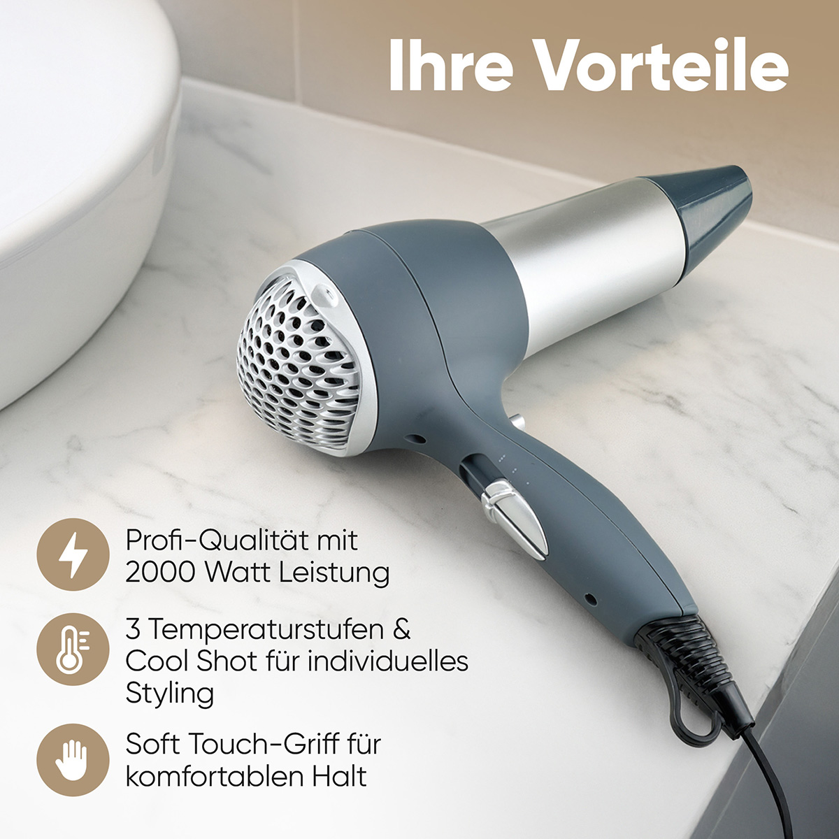 Szara i srebrna suszarka na marmurowej powierzchni. Tekst podkreśla 2000W, ustawienia temperatury i miękki uchwyt.