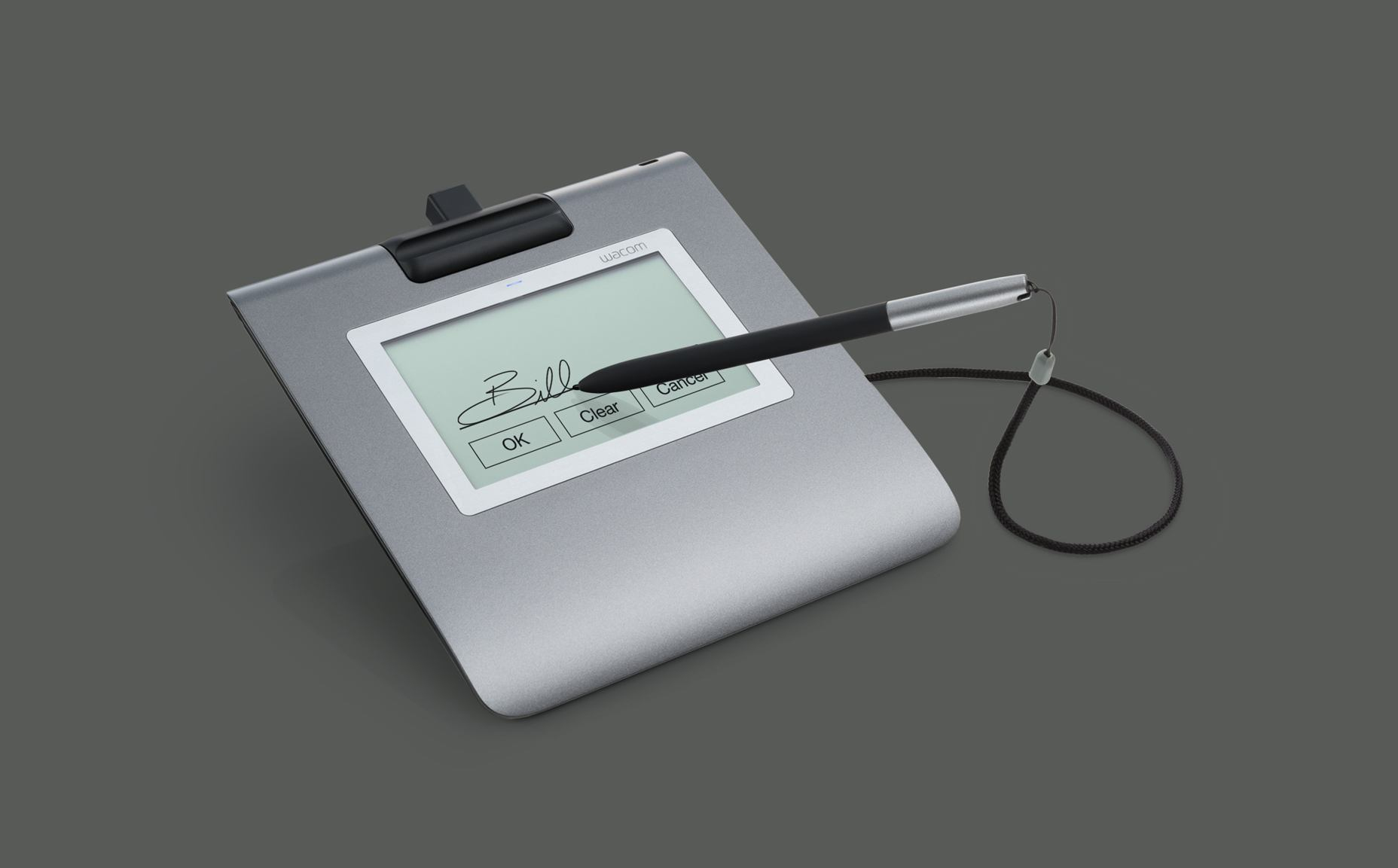 Ein silbernes Wacom-Signaturpad zeigt eine Unterschrift mit einem Stift. Buttons für OK, Clear und Cancel sind sichtbar.
