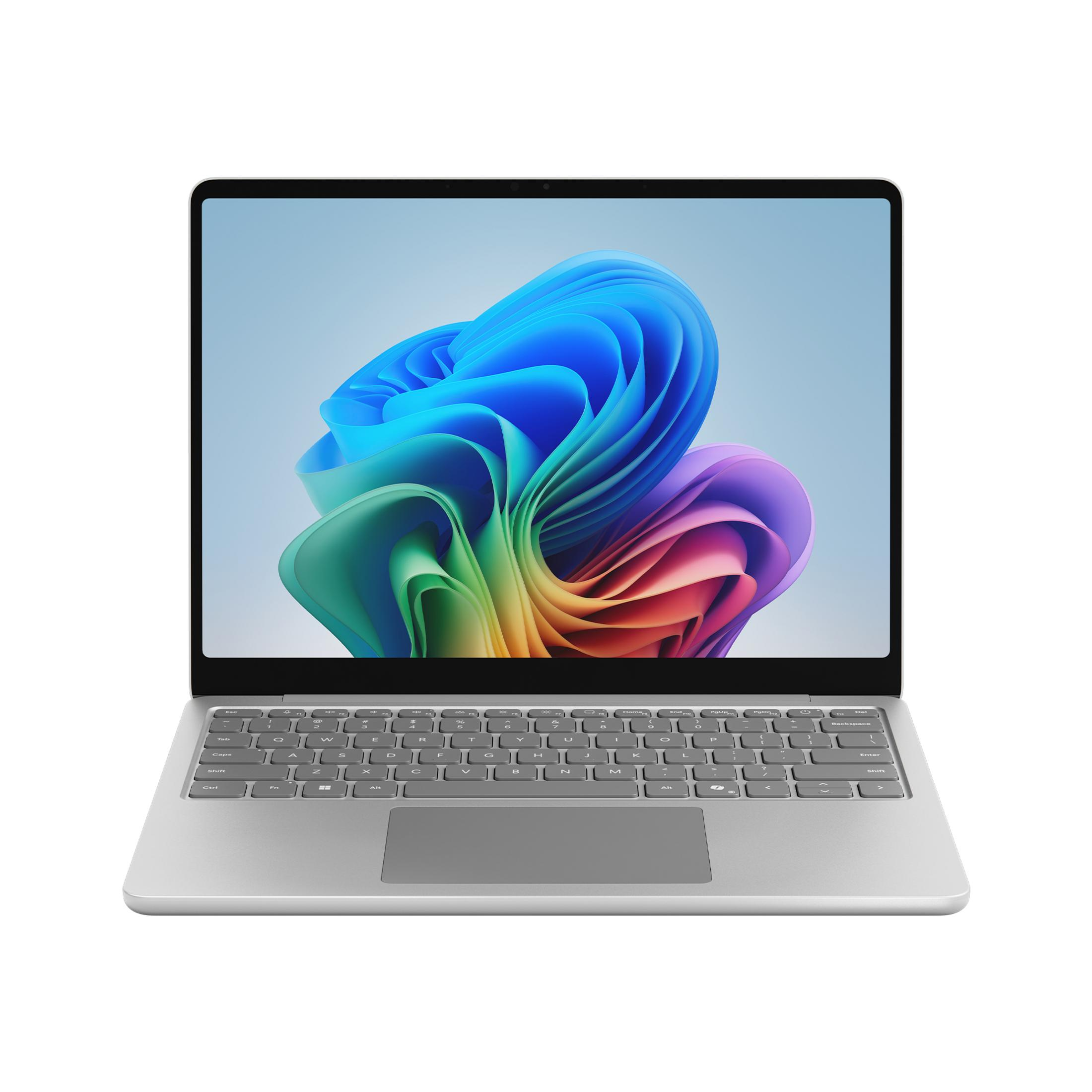 Otwarty srebrny laptop. Ekran wyświetla kolorowe abstrakcyjne kształty. Widoczna klawiatura i gładzik.