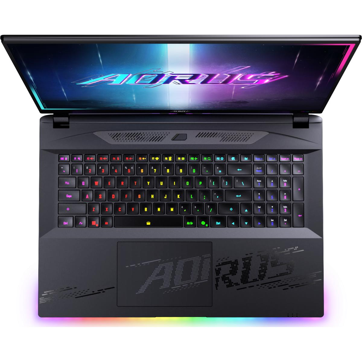 Ein schwarzer Laptop mit offenem Bildschirm, der das AORUS-Logo zeigt. Die Tastatur ist mit bunten Lichtern beleuchtet. Der Boden hat ein Logo.