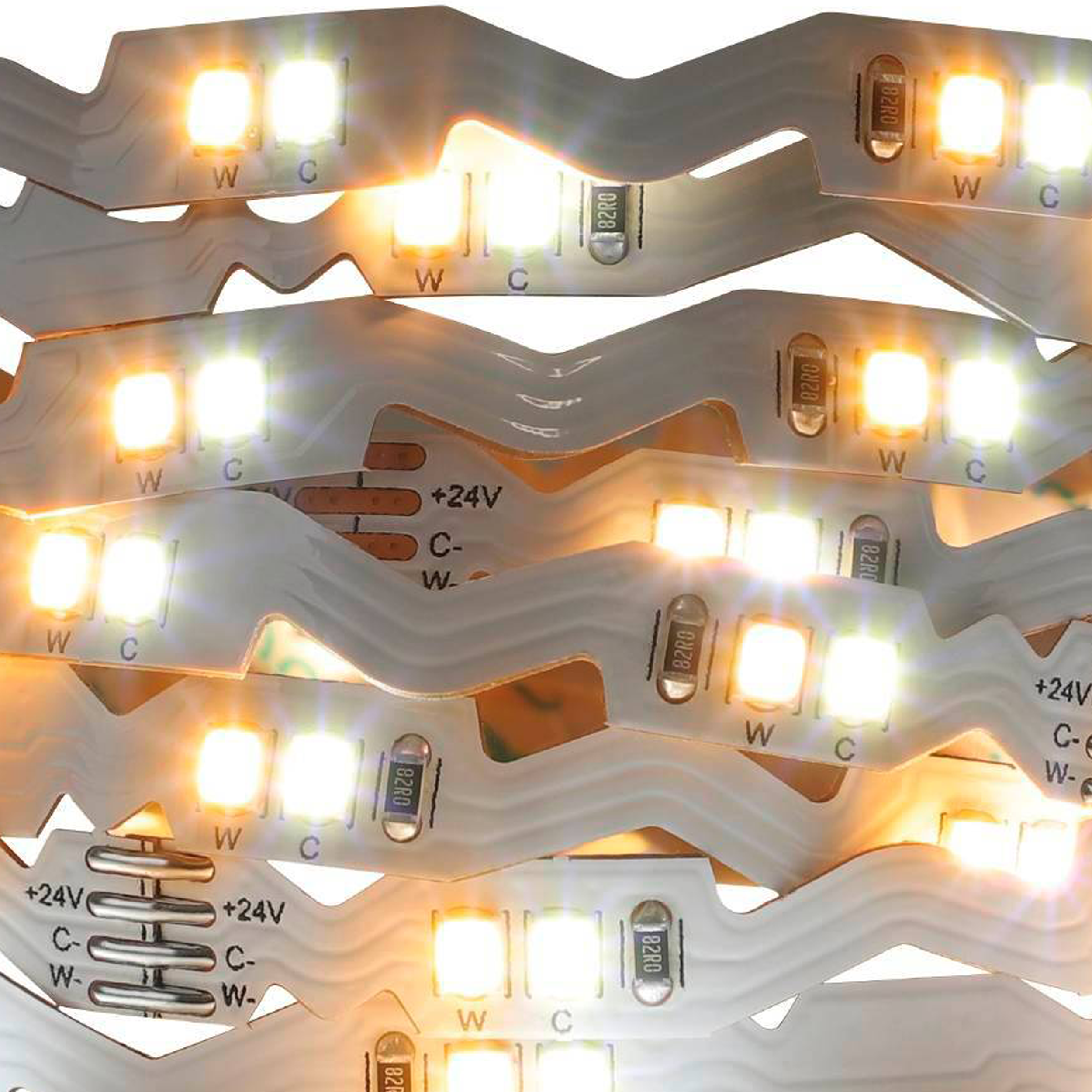 Un primo piano mostra una striscia LED flessibile, evidenziandone l'ingresso di alimentazione +24V e il design compatto.