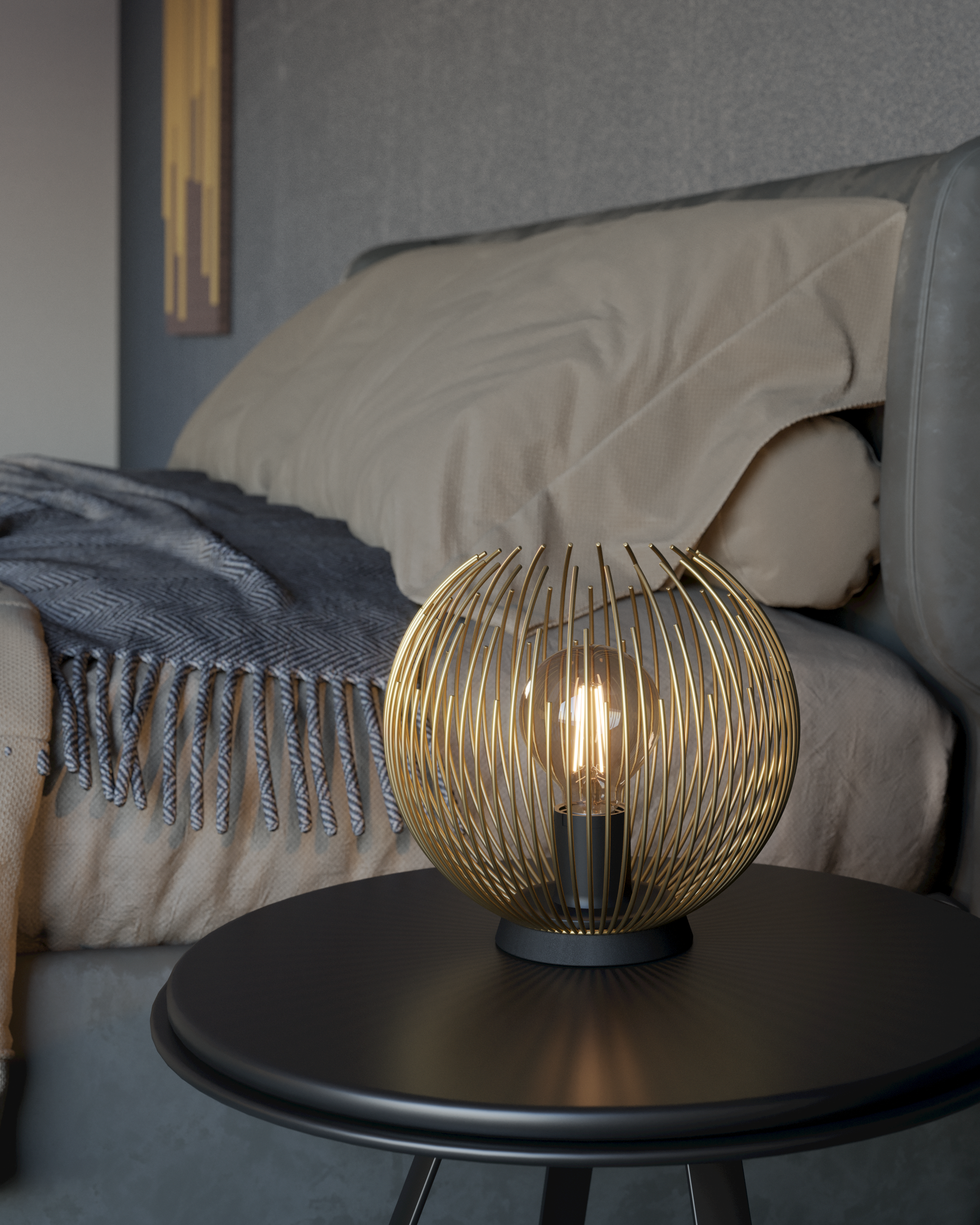 Lampada dorata su tavolo nero vicino a un letto. Lo sfondo è una stanza beige e grigia.