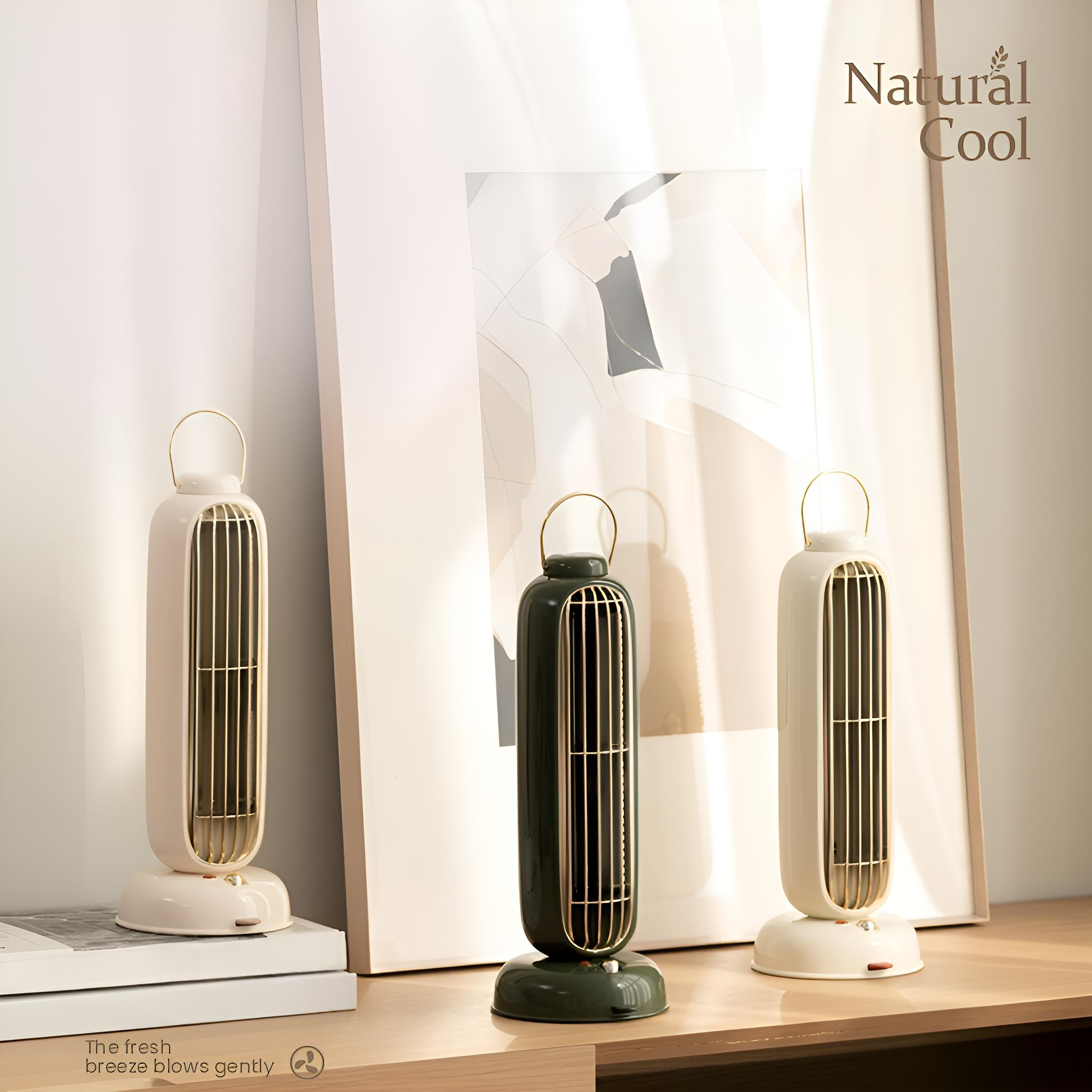 Drei Turmventilatoren, beige und grün, stehen auf einer Holzoberfläche vor einem gerahmten Bild und einer weißen Wand.
