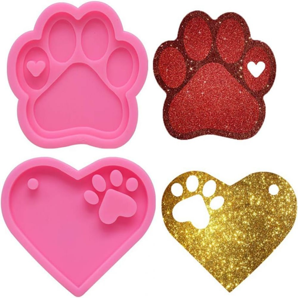 Vier Silikonformen: rosa Pfote, rote Glitzerpfote, rosa Herz und goldenes Glitzerherz, isoliert.