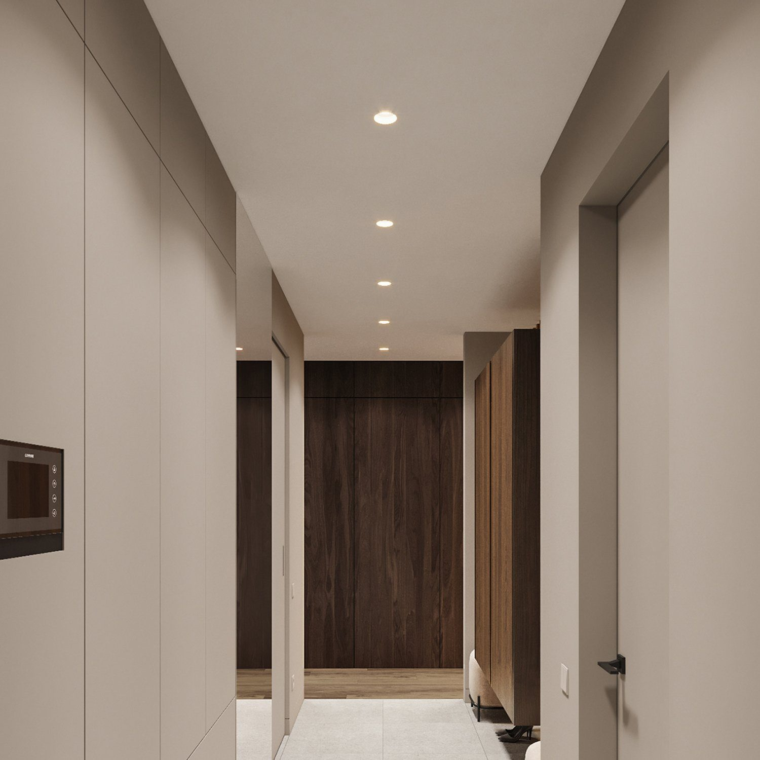 Corridoio interno con illuminazione incassata, pareti neutre e accenti di legno scuro.