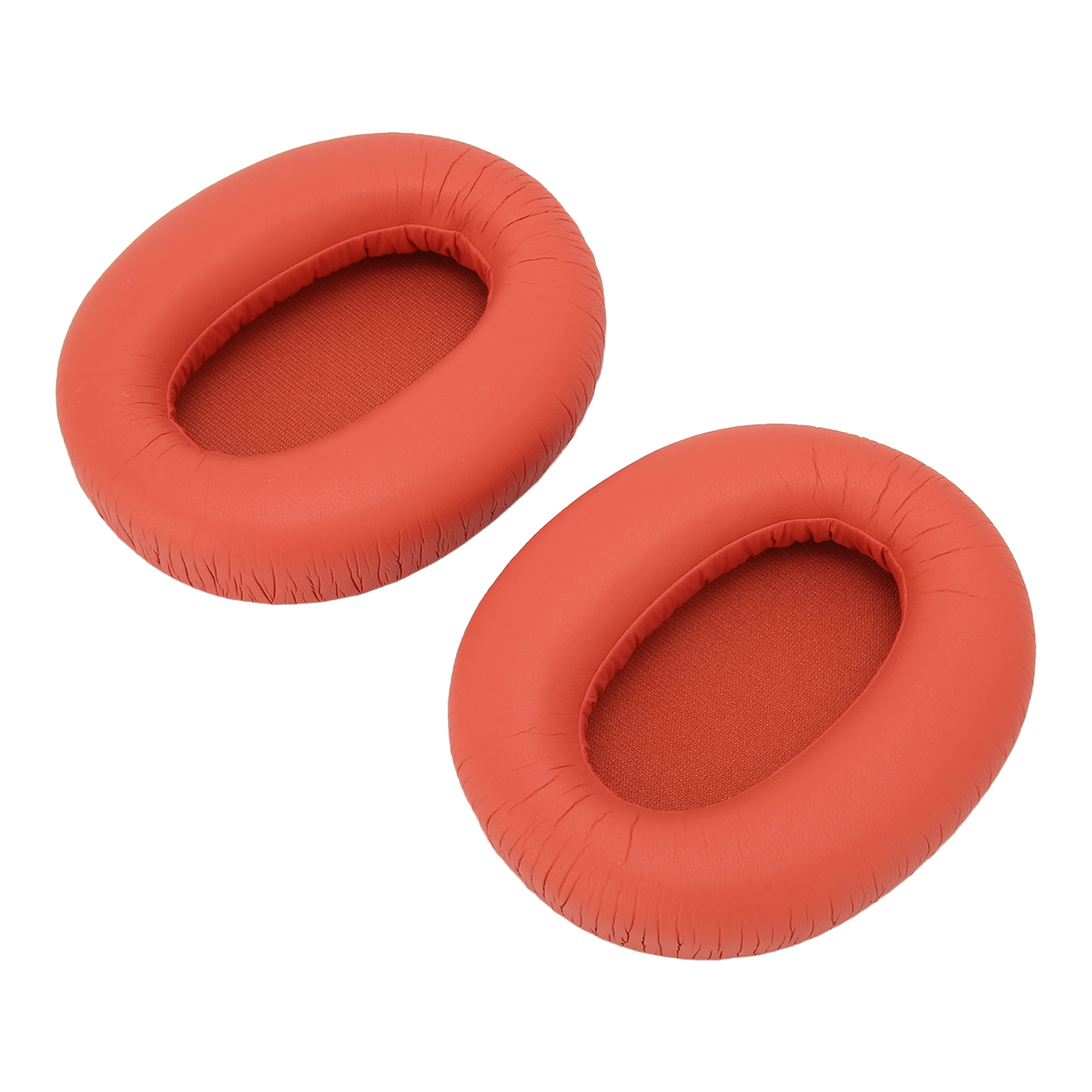 Zwei orangefarbene Kopfhörer-Ohrpolster. Sie sind rund mit strukturierter Oberfläche und aus weichem Material.