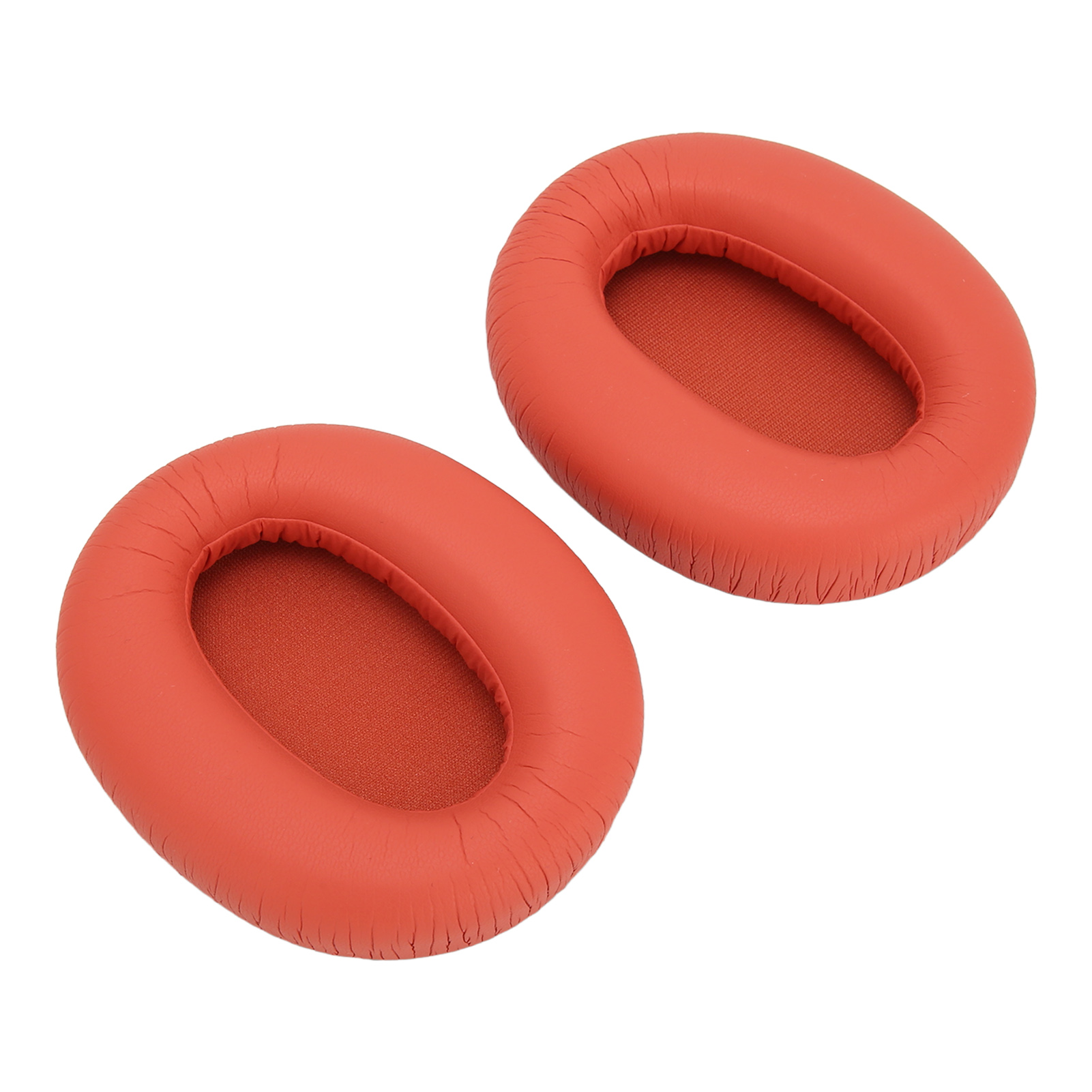 Zwei orangefarbene Kopfhörer-Ohrpolster. Sie sind rund und haben eine strukturierte orange Oberfläche.