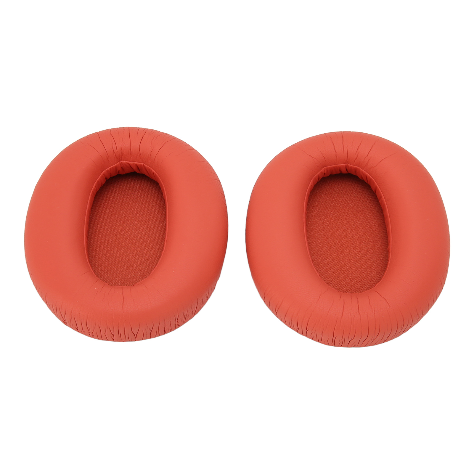 Zwei orangefarbene Kopfhörer-Ohrpolster. Sie sind rund und haben eine glatte, orange Oberfläche.