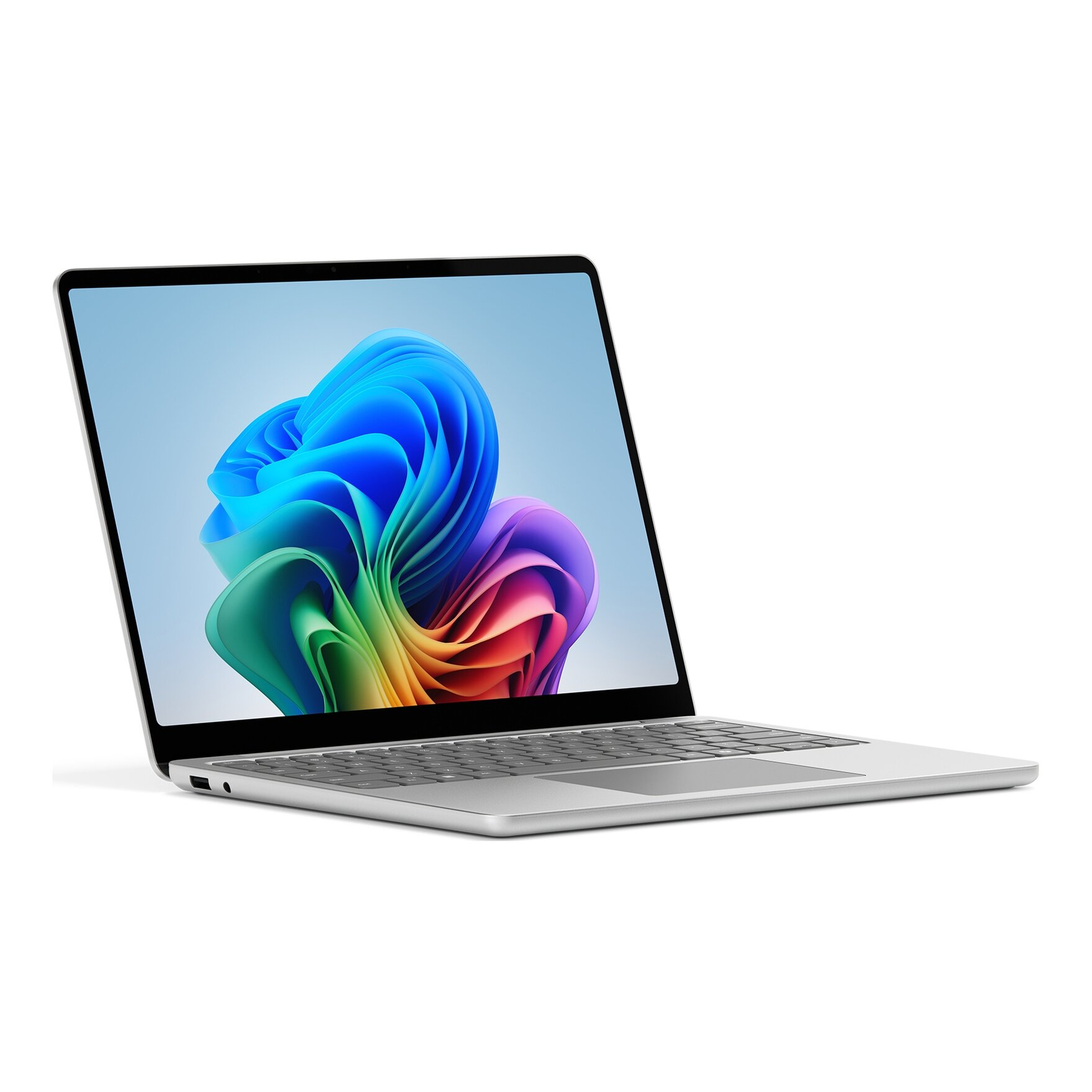 Laptop con cornice argentata, aperto su un tavolo. Lo schermo mostra forme astratte colorate.