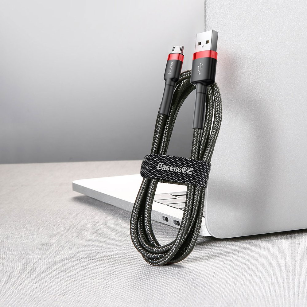 Czarny, pleciony kabel USB jest podłączony do telefonu, z power bankiem.