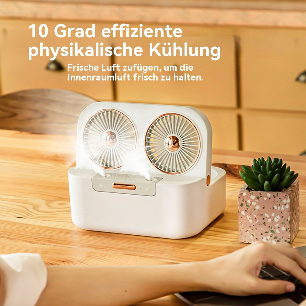 Weißer und goldener Ventilator mit zwei Lüftern. Rechts steht eine kleine grüne Pflanze.