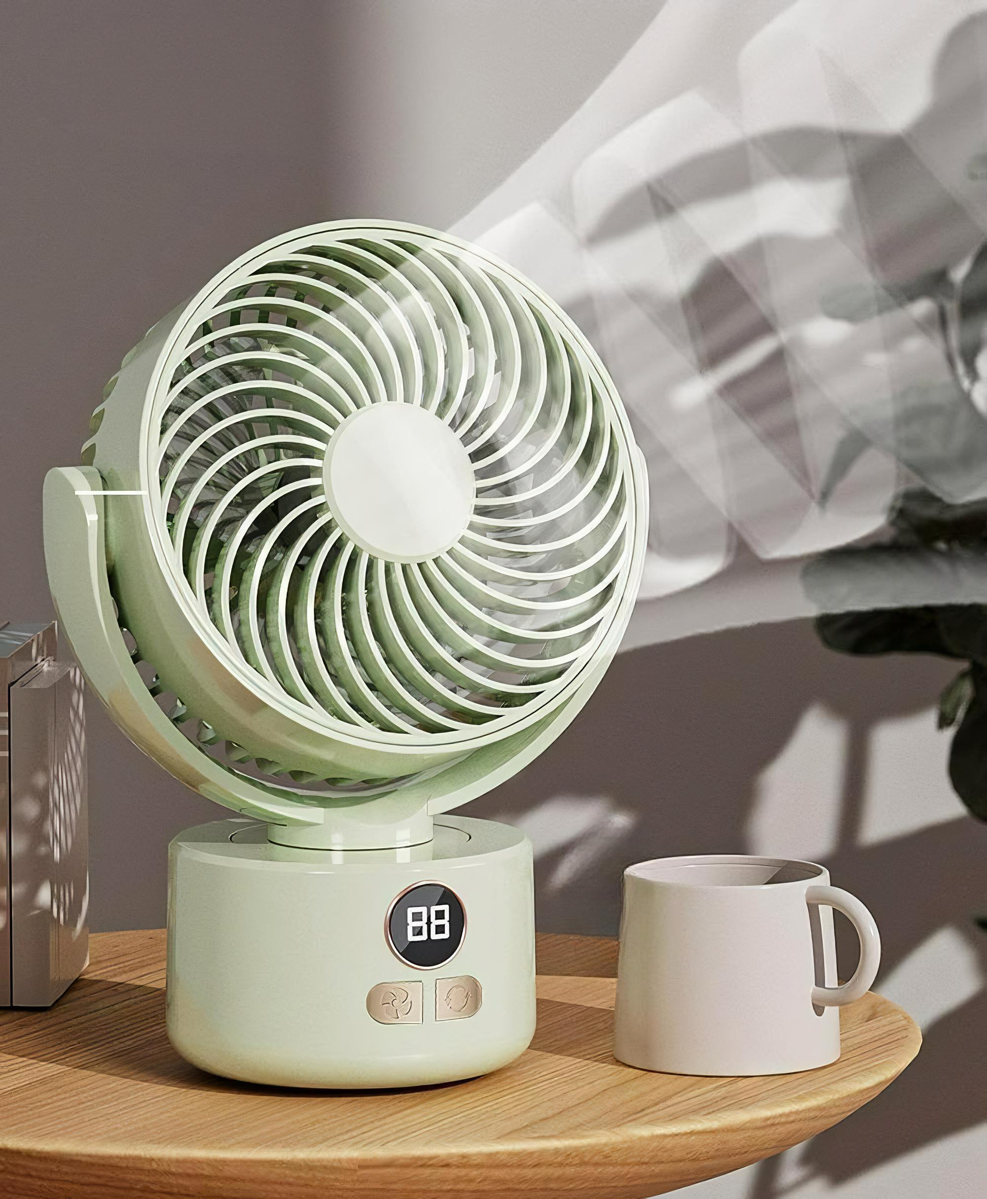 Ein grüner Ventilator mit Digitalanzeige auf einem Holztisch, daneben eine weiße Tasse, die Luft bläst.
