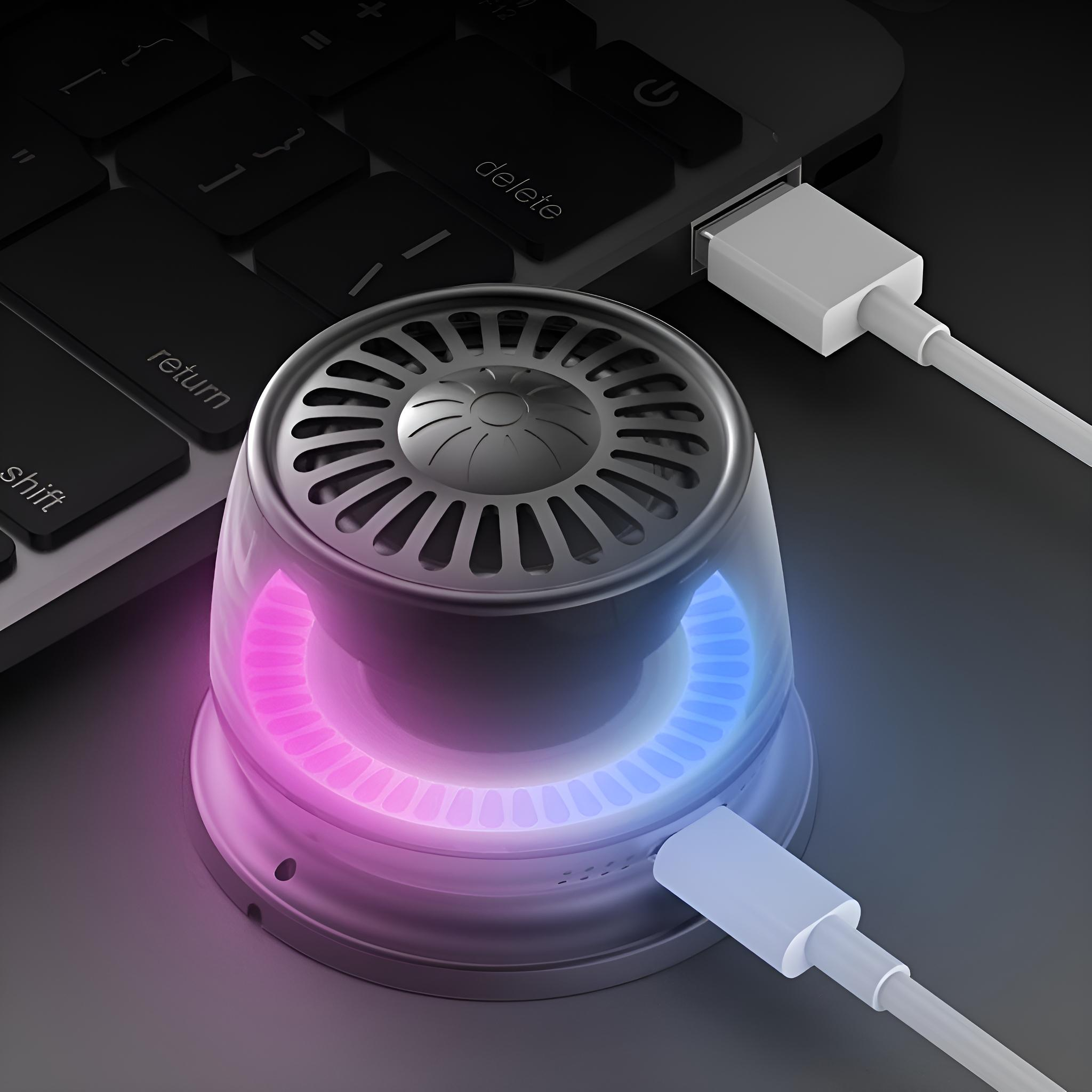 Ein schwarzes Gerät mit leuchtendem Ring ist mit einem Laptop verbunden.