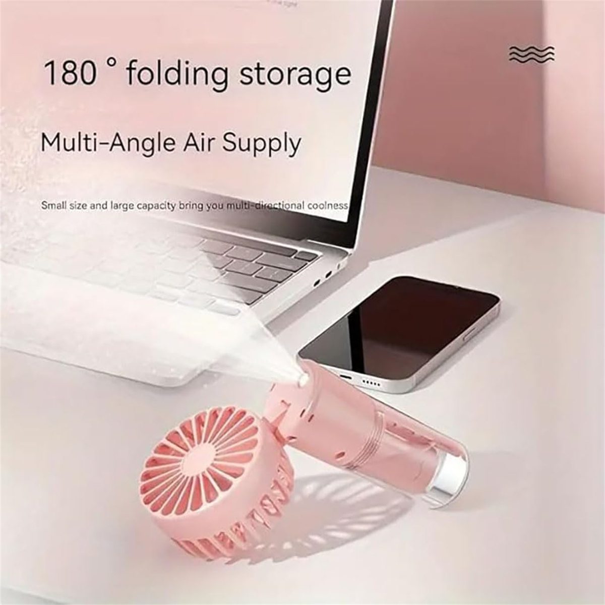 Ein rosa Handventilator neben Laptop und Telefon. Text: '180° Faltlagerung' und 'Multi-Winkel-Luftzufuhr'.
