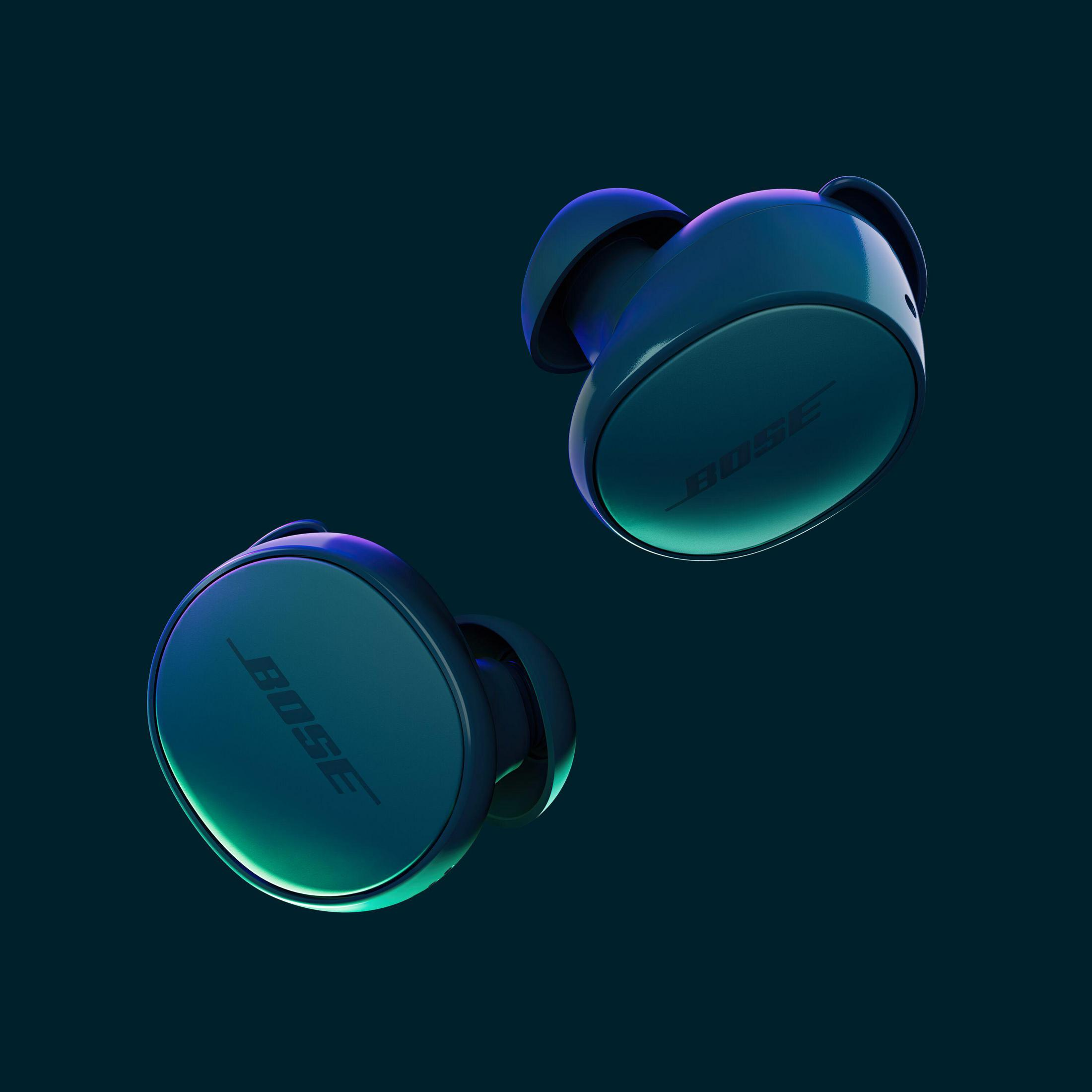 Dos auriculares azules flotando con un fondo degradado de color verde azulado oscuro y morado.
