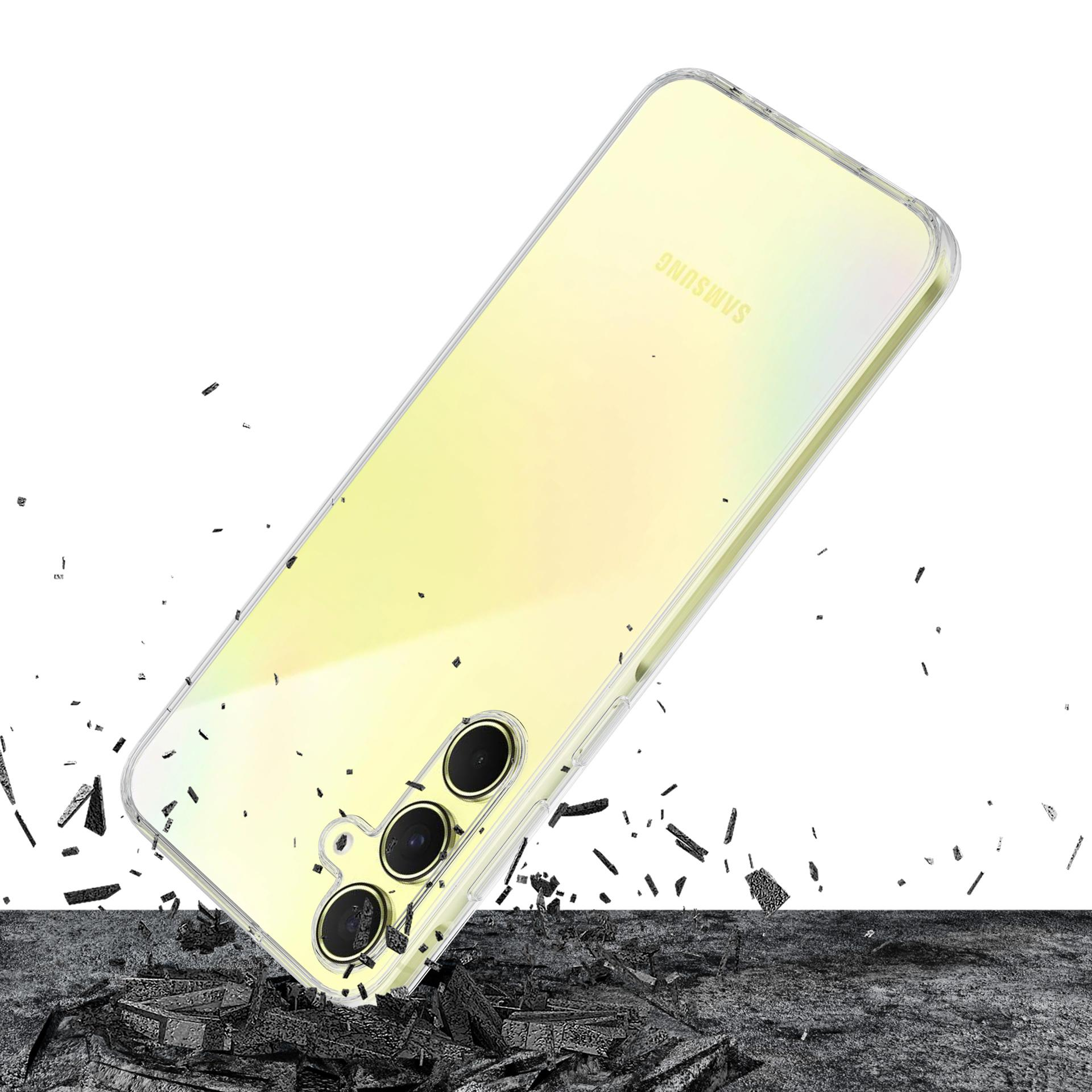 Żółty telefon Samsung w przezroczystym etui, spadający na ciemną powierzchnię ze gruzem.