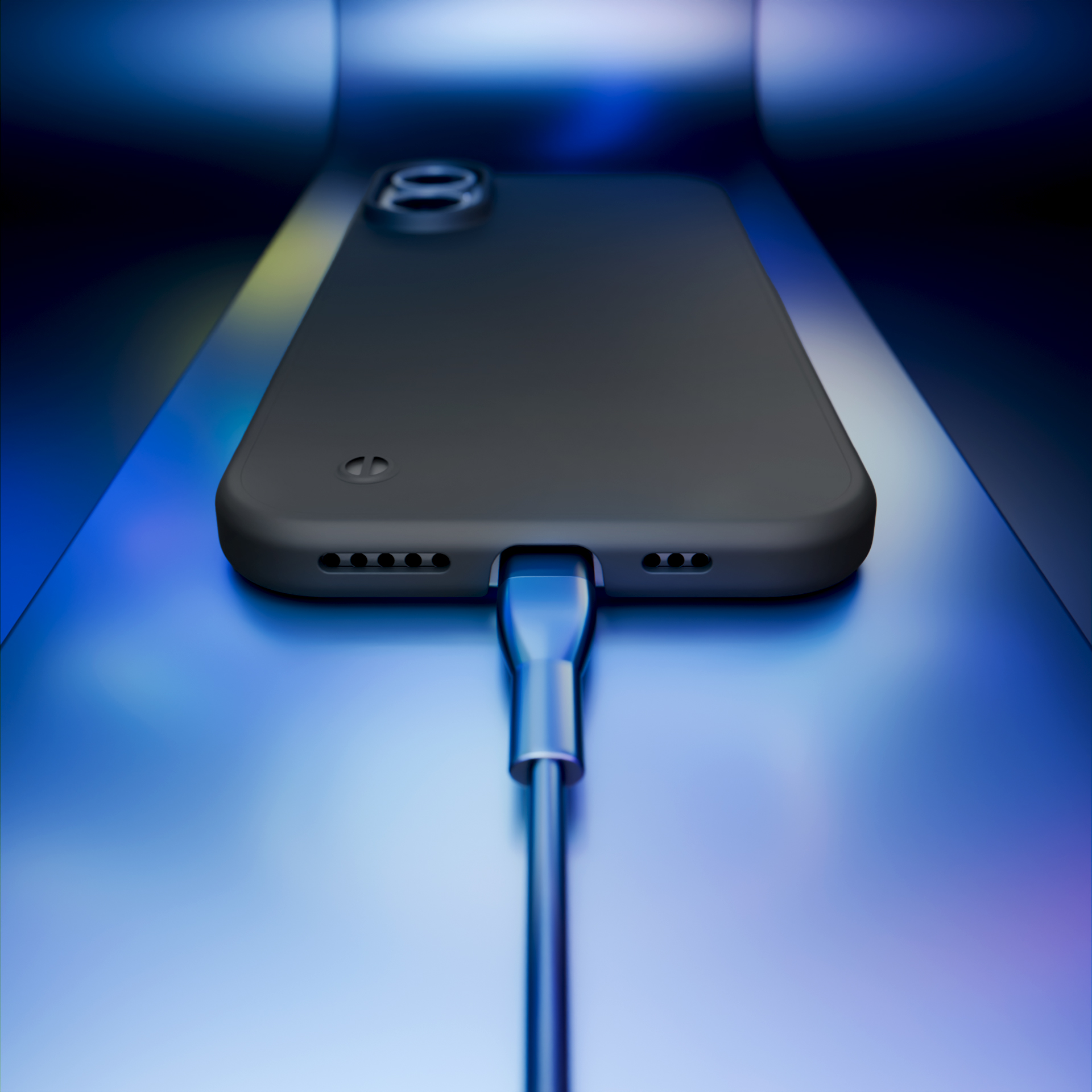 Czarny telefon z szarym etui jest ładowany za pomocą srebrnego kabla.