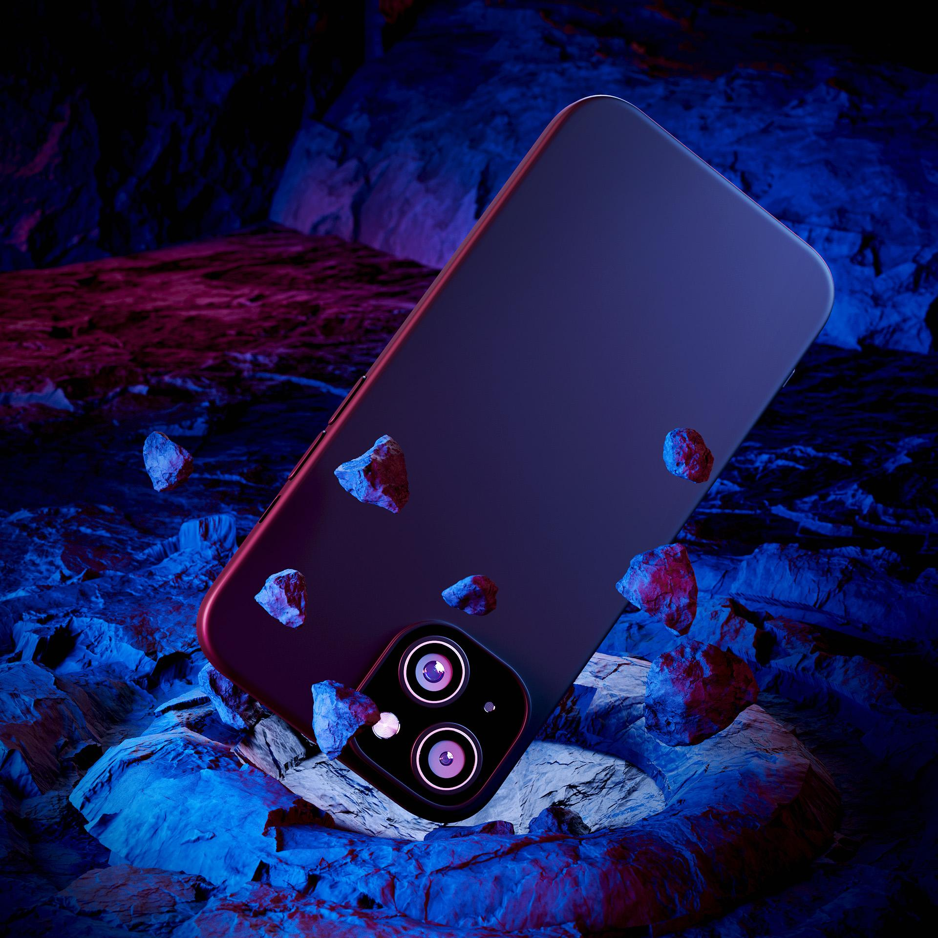 Granatowy telefon otoczony jest małymi kamieniami na teksturowanej, kolorowej powierzchni.