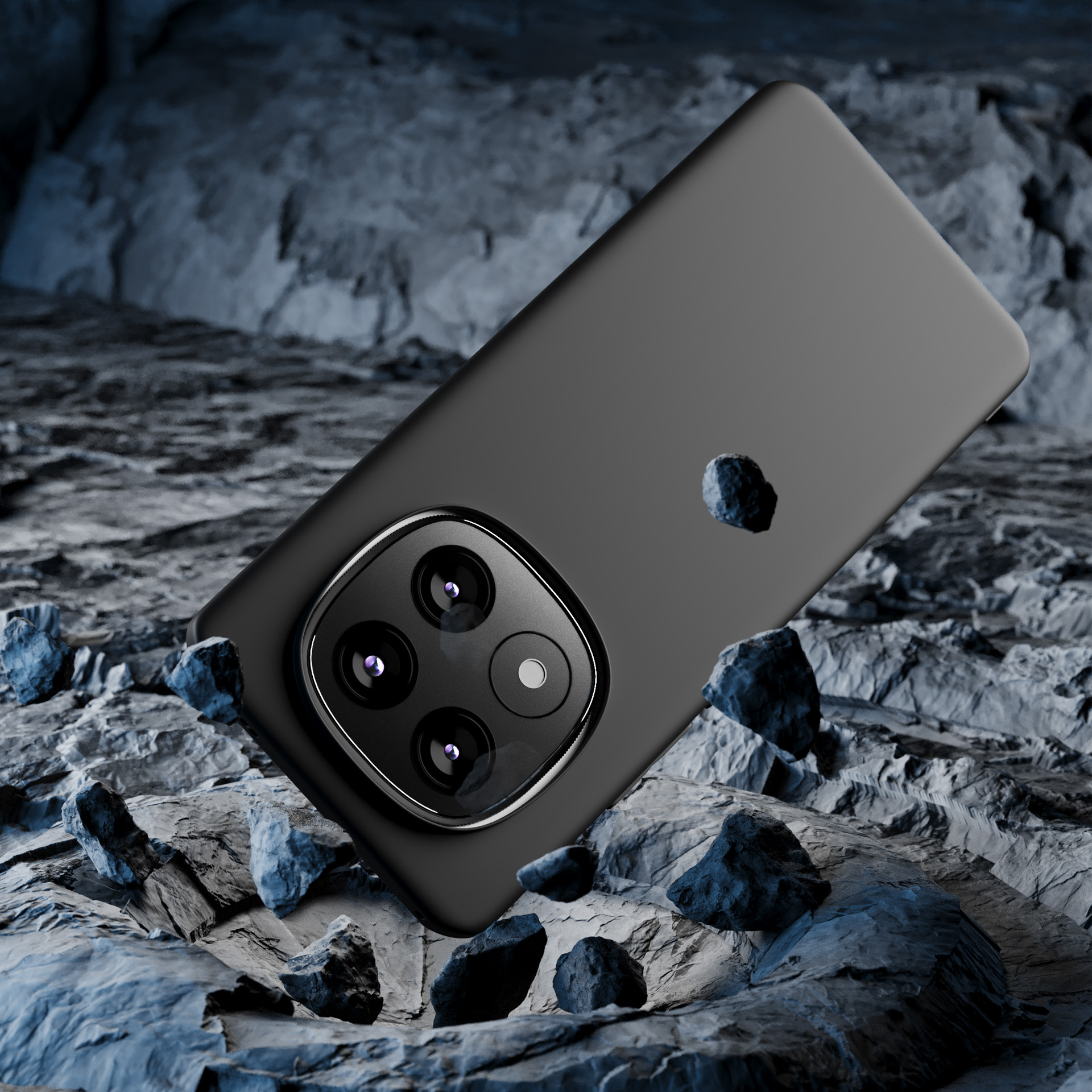 Czarny telefon leży na szarej, kamienistej powierzchni z rozrzuconymi wokół małymi kamieniami.