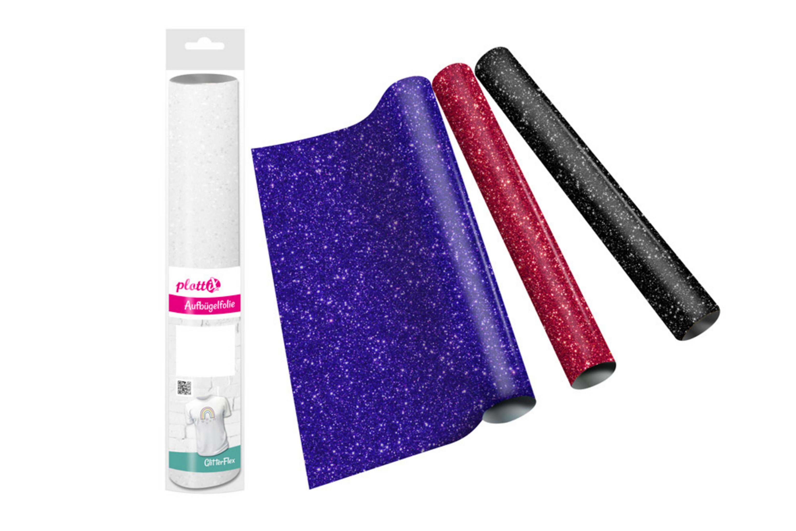 Rolle weißes Glitzer-Vinyl, violette und rote Bögen und eine Rolle schwarzes Glitzer-Vinyl auf weißem Hintergrund.