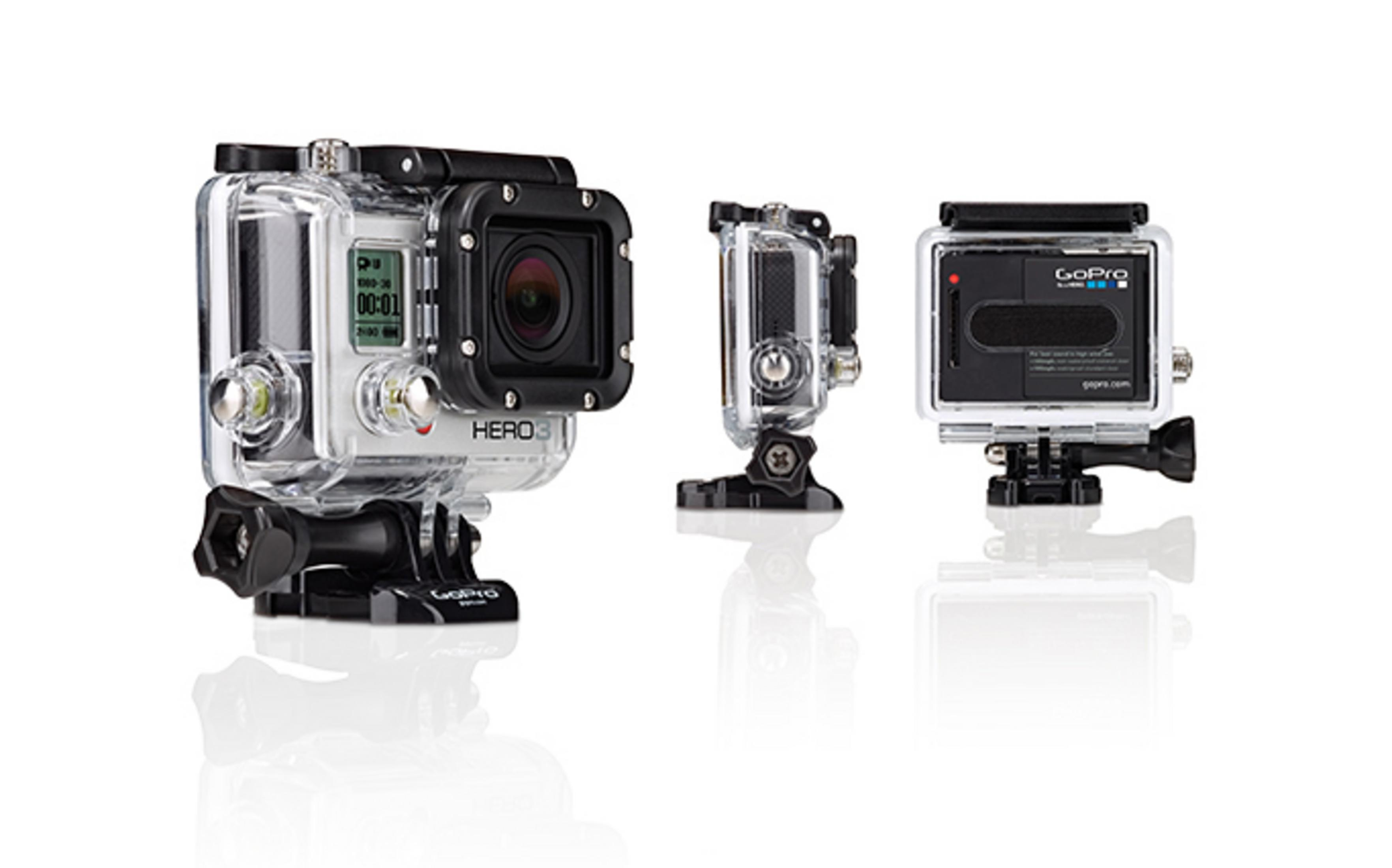 Drei GoPro Hero3-Kameras in wasserdichten Gehäusen, die auf einem weißen Hintergrund mit reflektierenden Oberflächen ausgestellt sind.