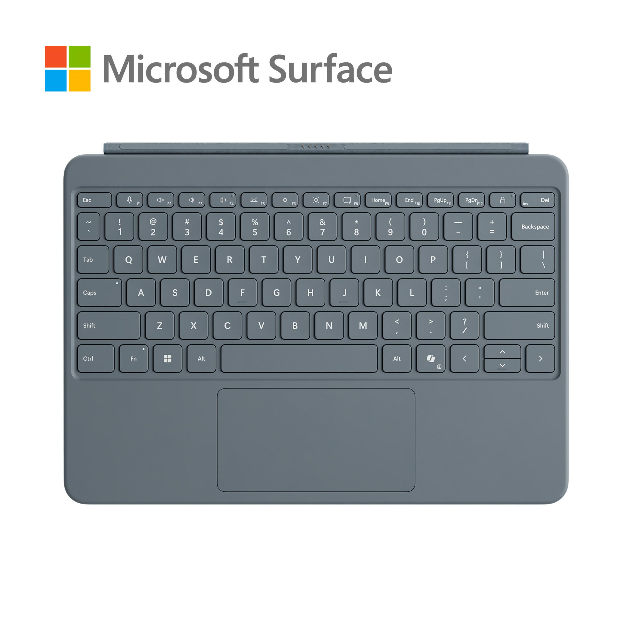 Una cover tastiera grigia Microsoft Surface. Ha tasti, un touchpad e un logo.