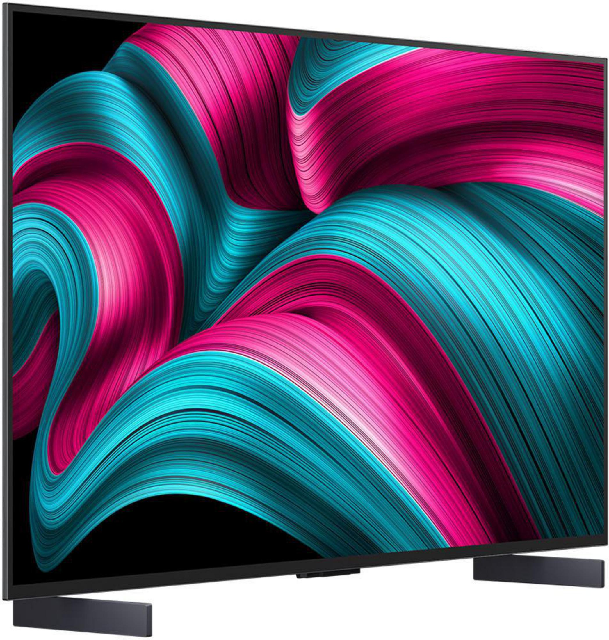 Ein moderner Fernseher mit schwarzem Rahmen, unterstützt von zwei Ständern. Der Bildschirm zeigt ein abstraktes Muster.