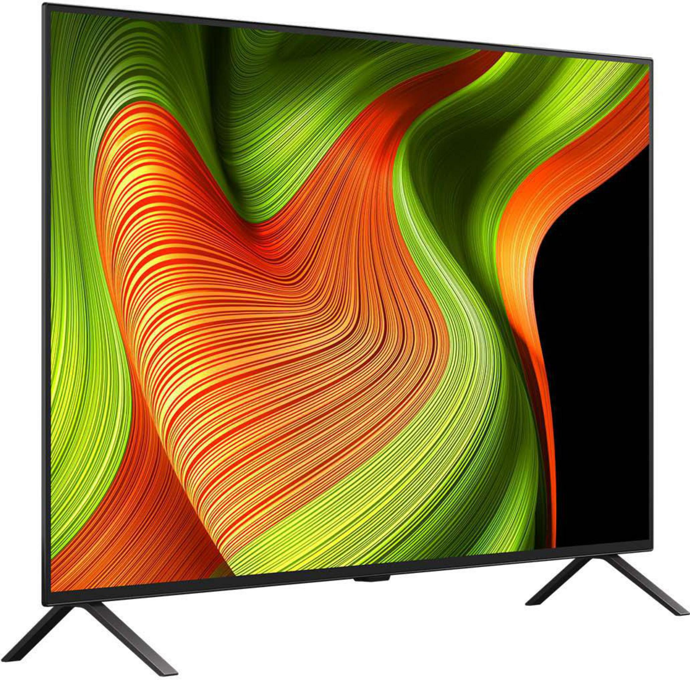 Un téléviseur moderne affiche un design abstrait et dynamique en vert, orange et noir sur un support sombre.