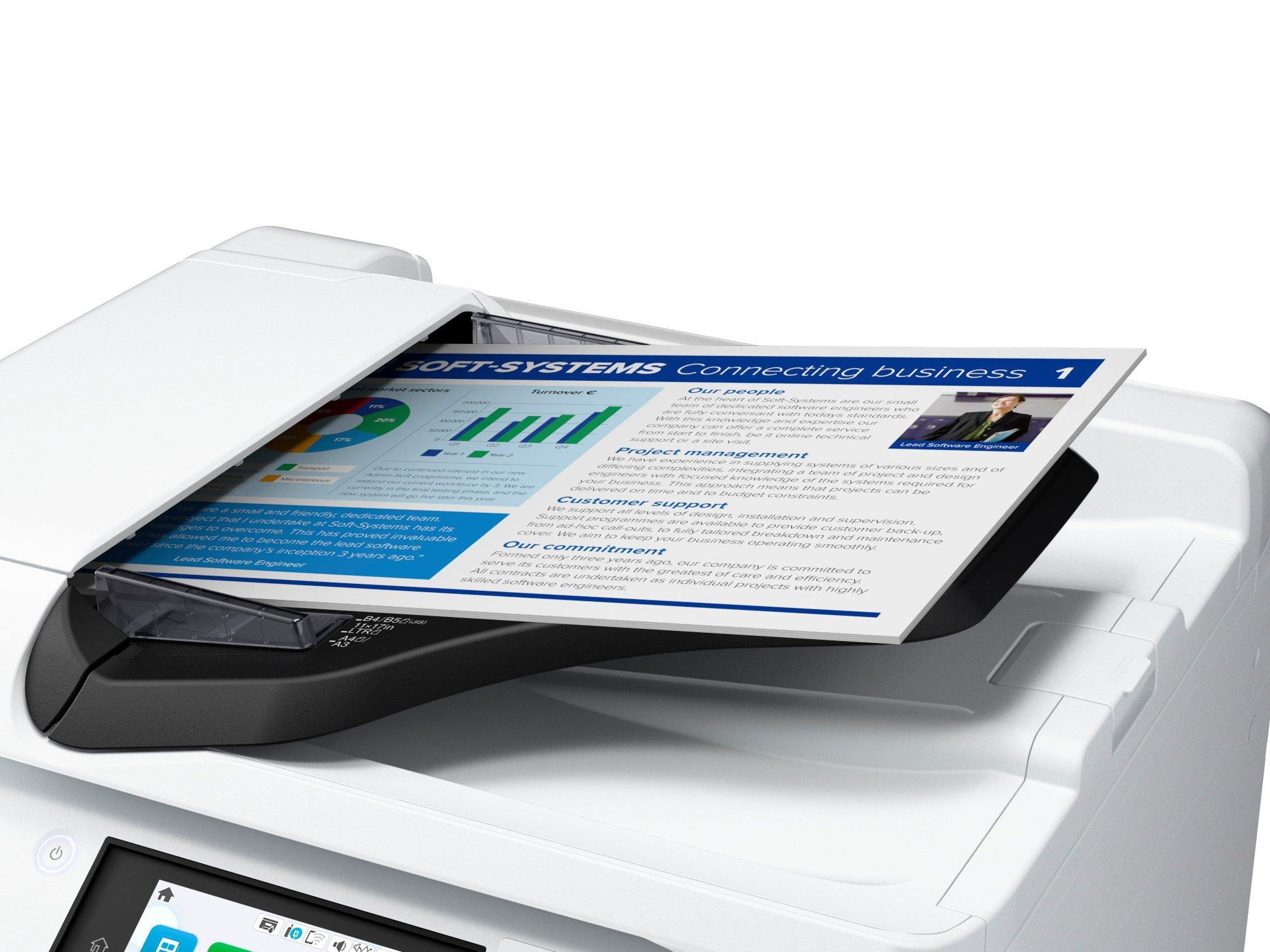 Drukarka skanuje dokument. Dokument zawiera wykresy i tekst o biznesie.