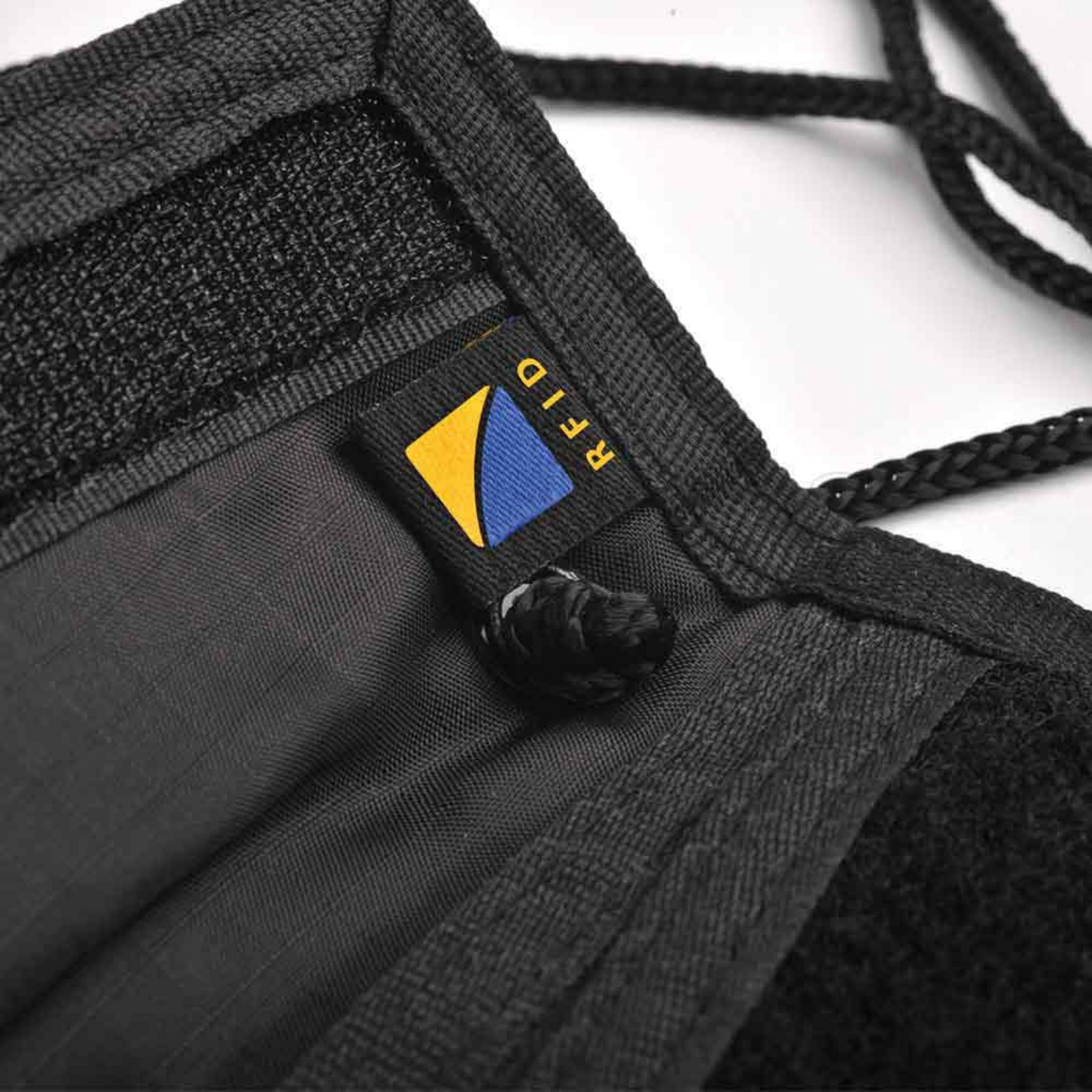 Nahaufnahme einer schwarzen RFID-Reisetasche. Das Logo ist gelb und blau und zeigt 'RFID'.