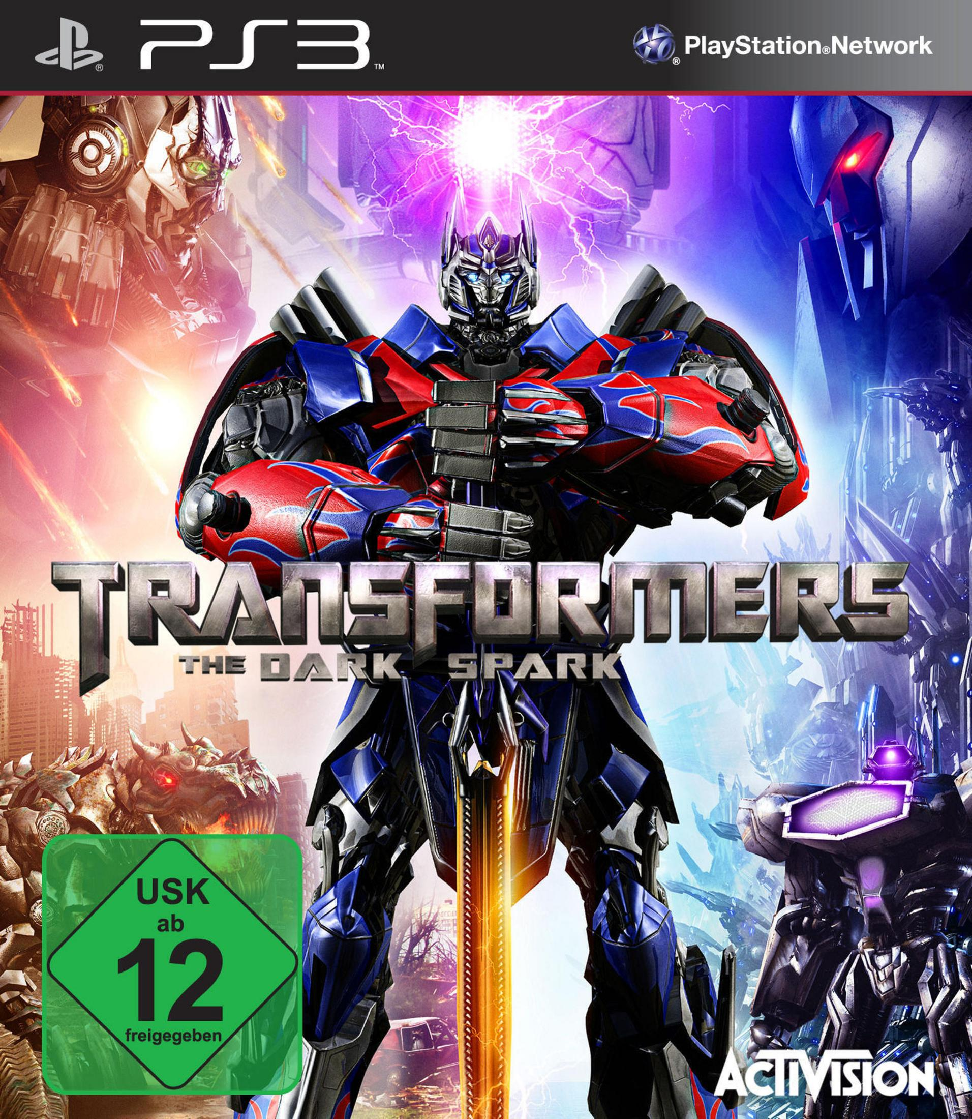 Transformers: The Dark Spark PS3-Spielcover mit Optimus Prime vor einer Kulisse von Stadtruinen und Robotern.